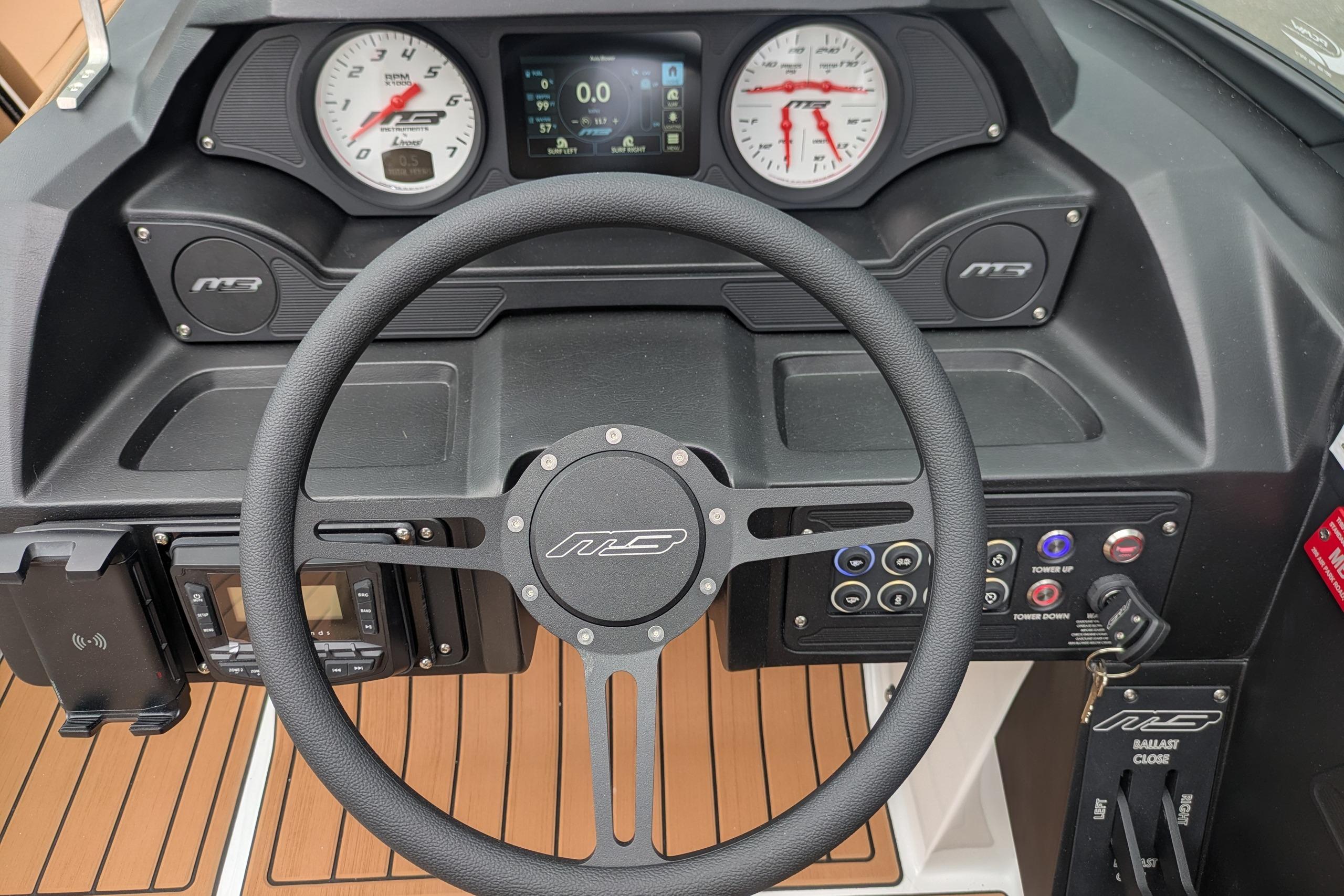 Steering wheel and dashboard of 2026 MB B52-23 Classic LIMITED boat, featuring modern controls.