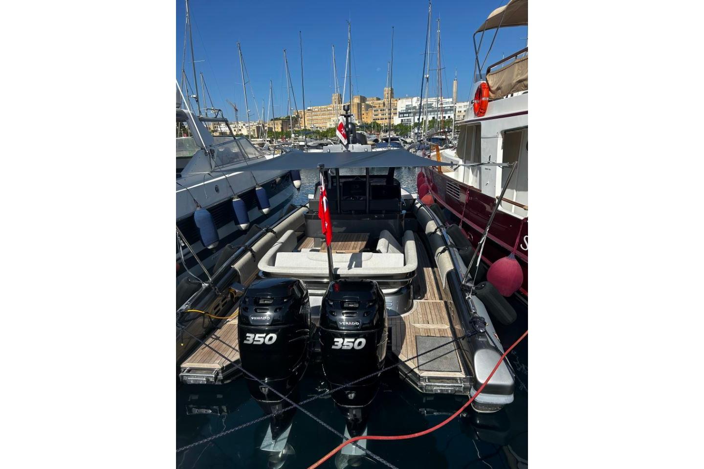 Novamarine Black Shiver 100, 2021 model, docked with twin 350 engines, in a marina setting.