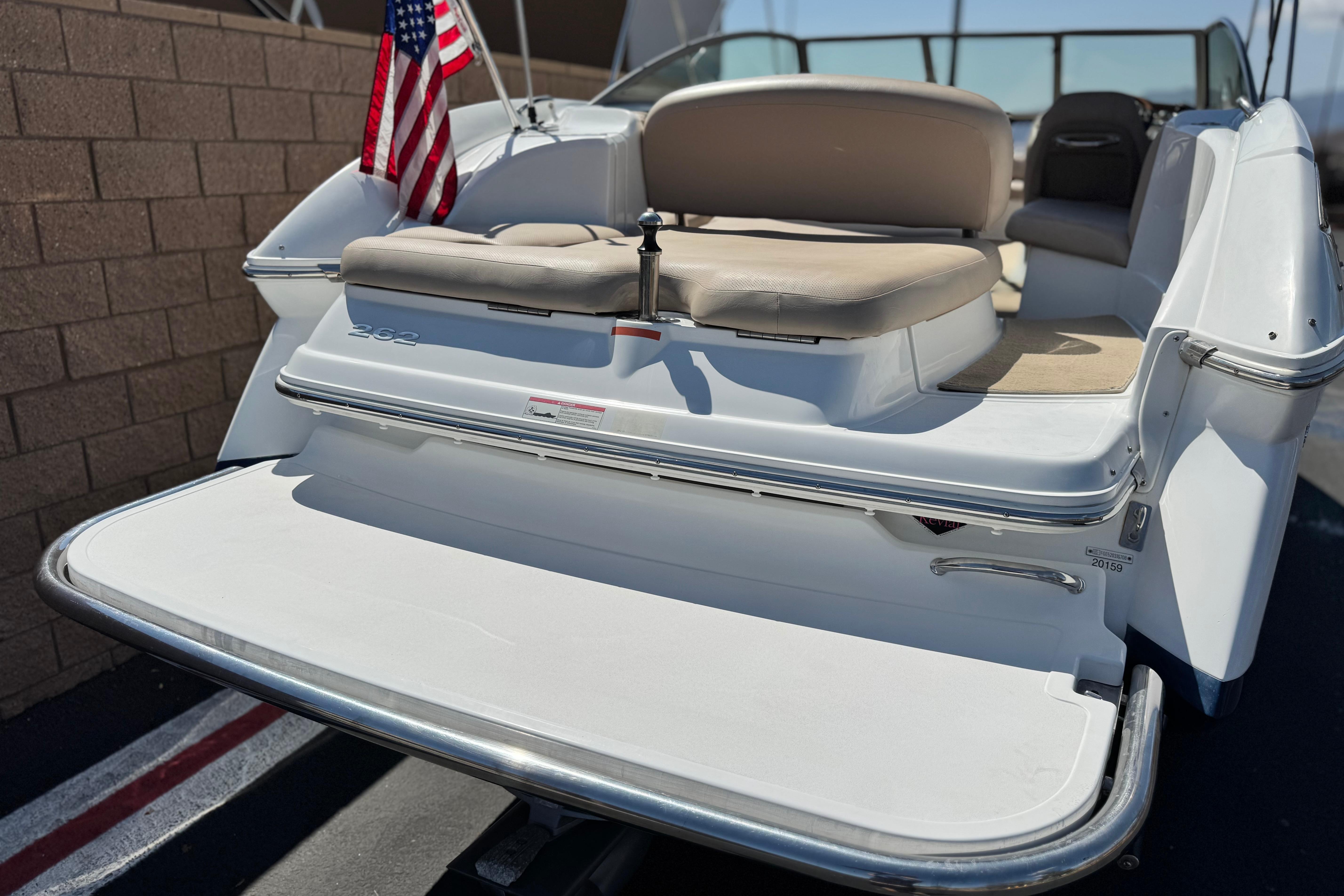 2008 Cobalt 262 boat with American flag, rear view showing seating and swim platform.