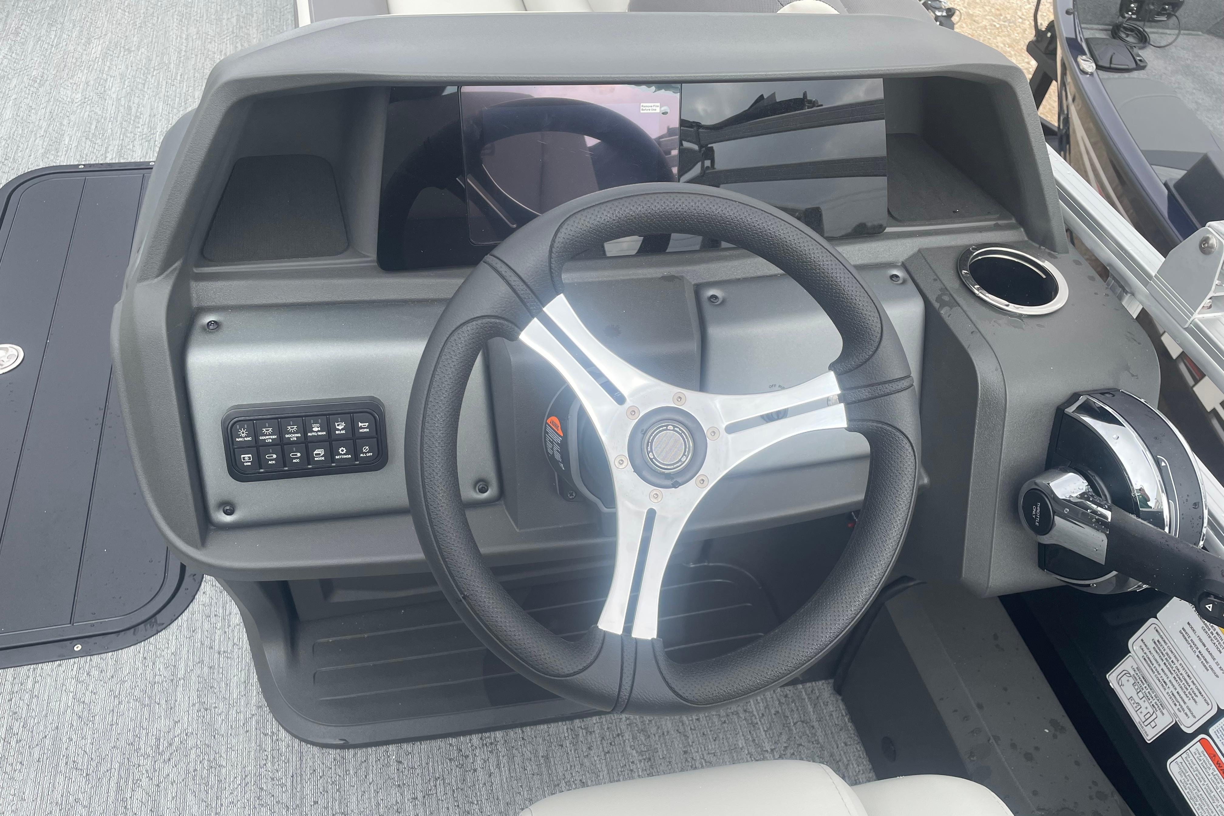 2026 Sun Tracker Fishin' Barge 22 XP3 steering console with modern controls and cup holder.