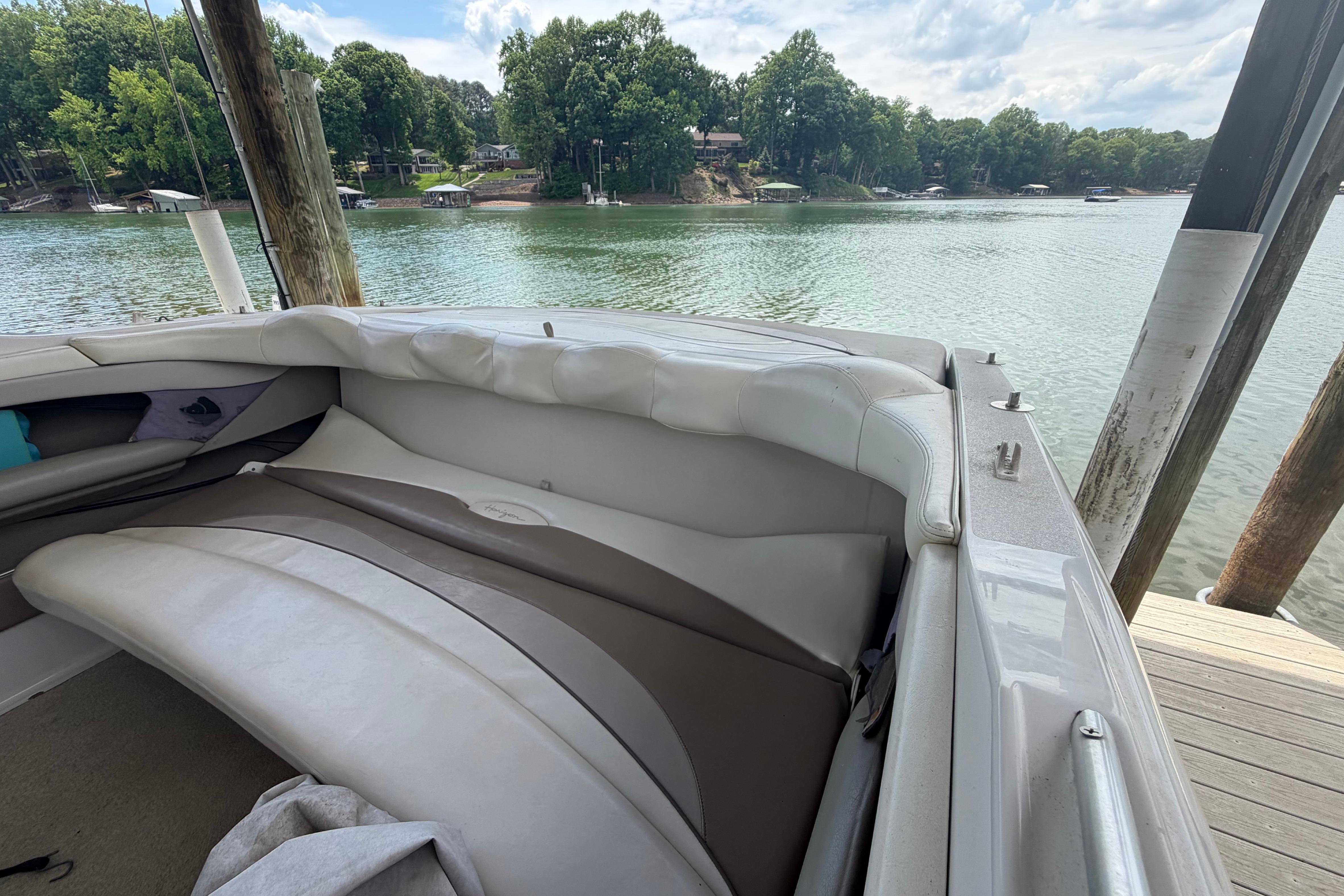1998 Four Winns 220 Horizon boat interior with lake view and dock.