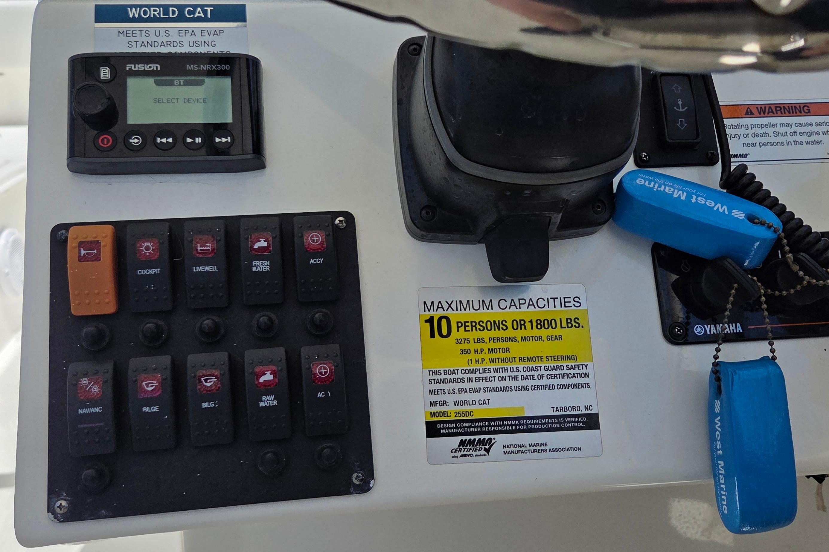 Control panel of 2022 World Cat 255 DC boat with capacity and safety labels.