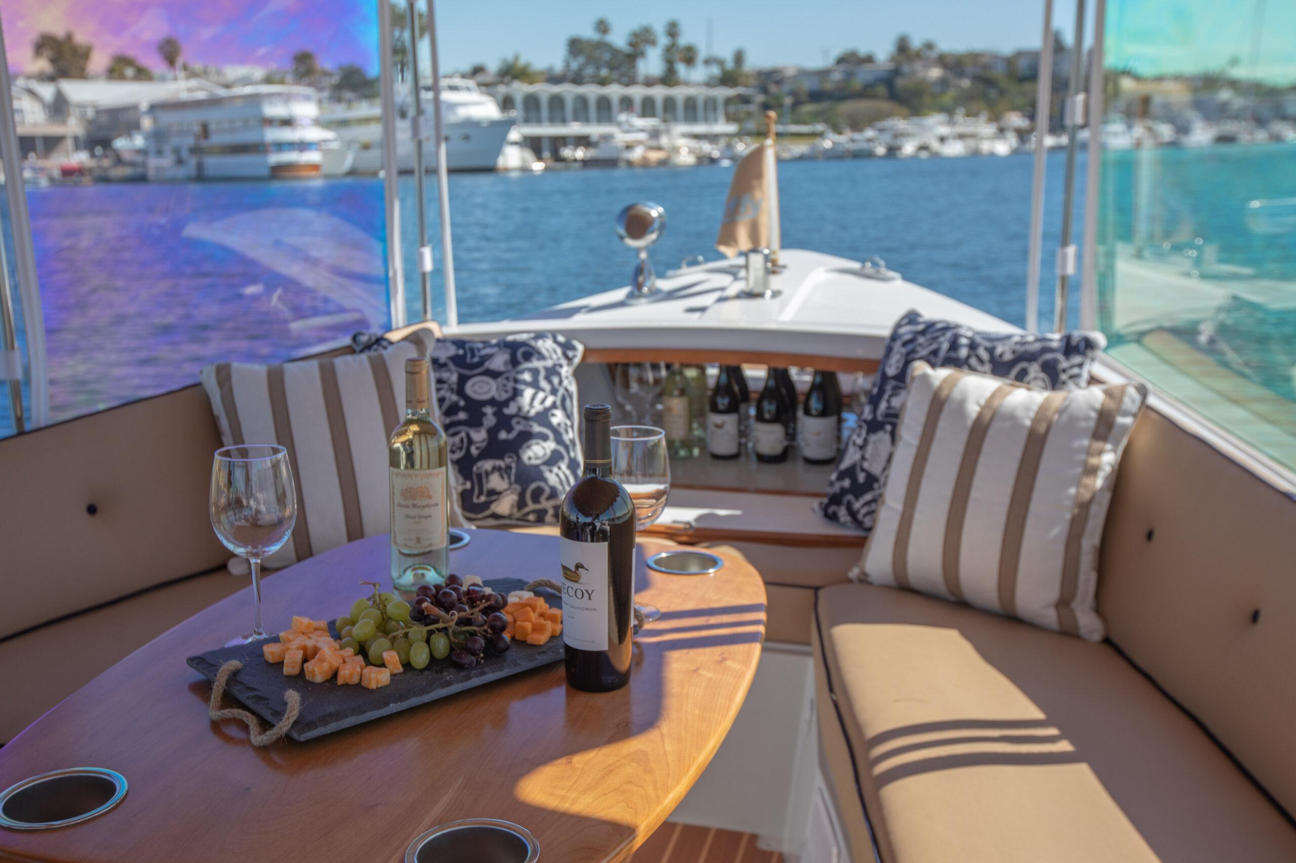 Luxurious 2026 Duffy Bay Island boat with wine and cheese setup on deck.