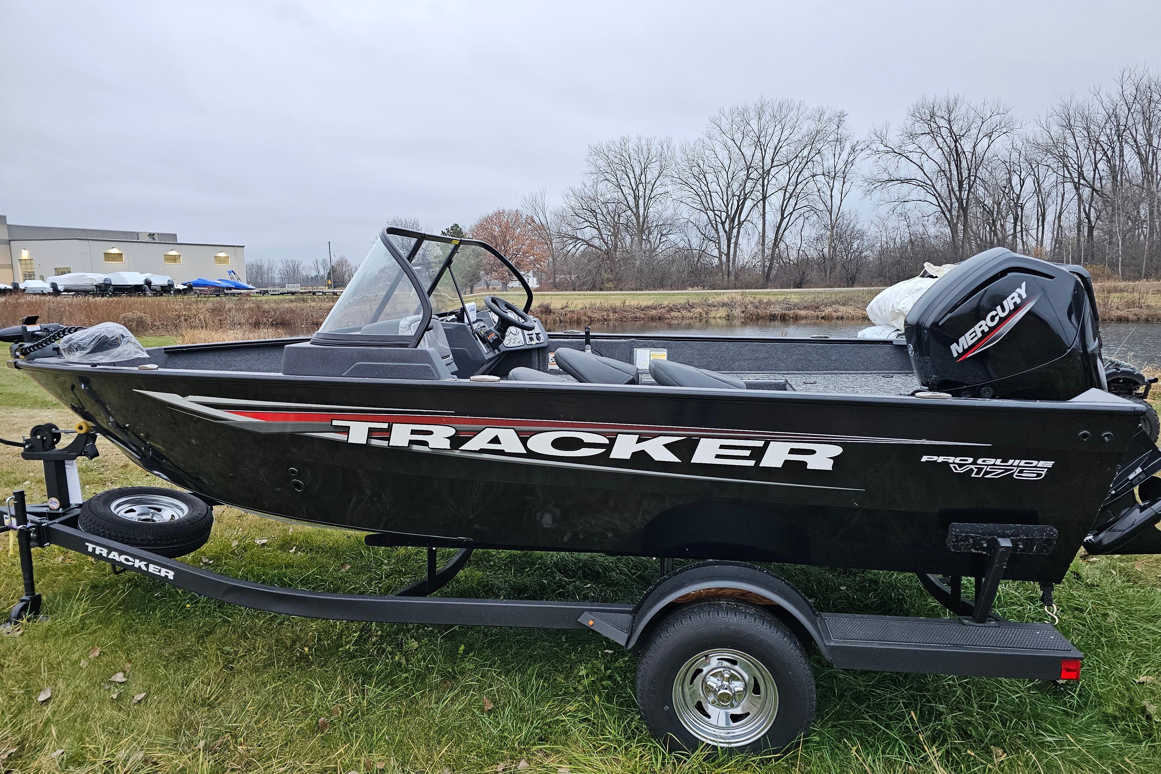 2026 Tracker Pro Guide V-175 WT boat on trailer, parked on grass.