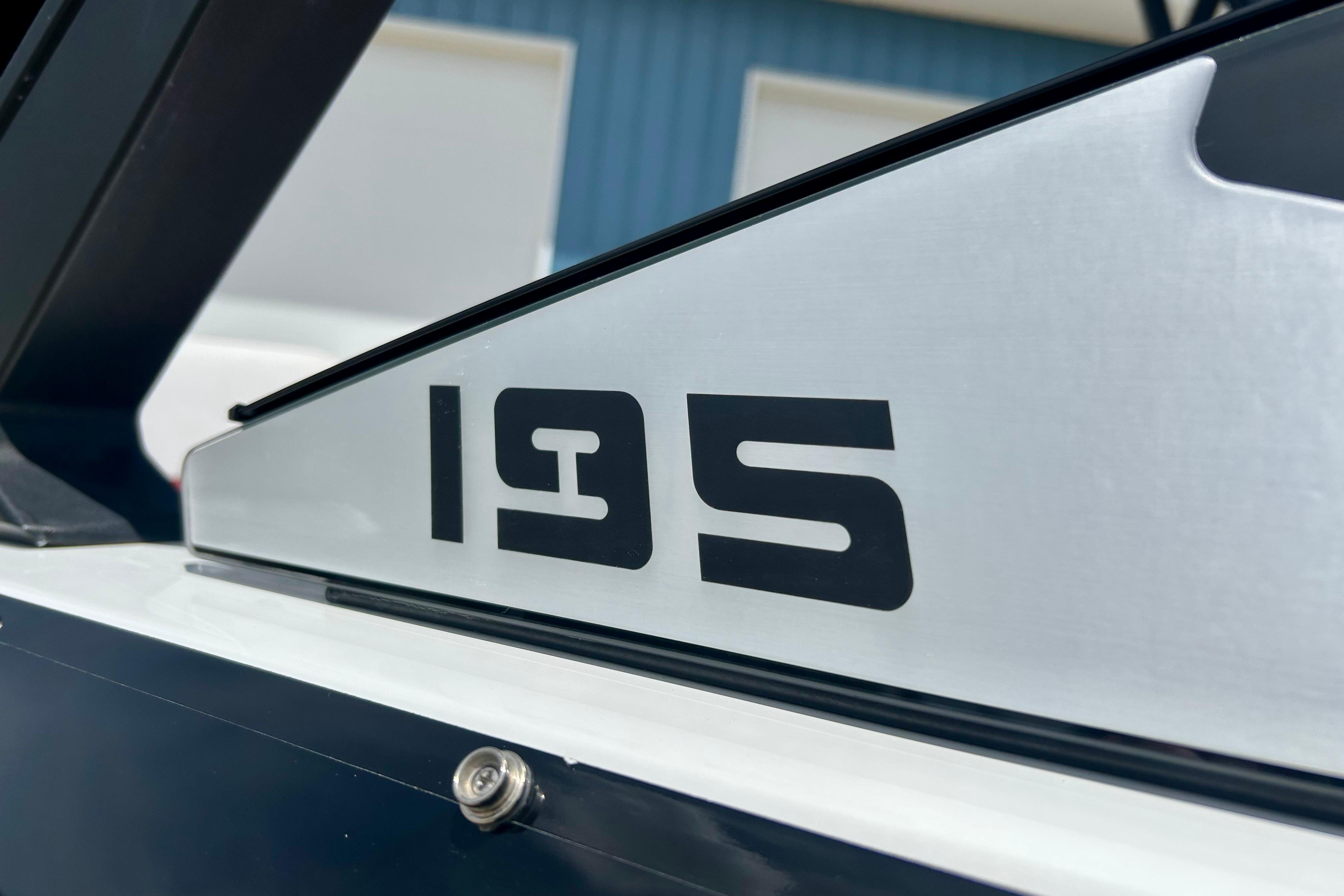 Close-up of 2021 Scarab 195 ID boat model number on sleek metallic surface.