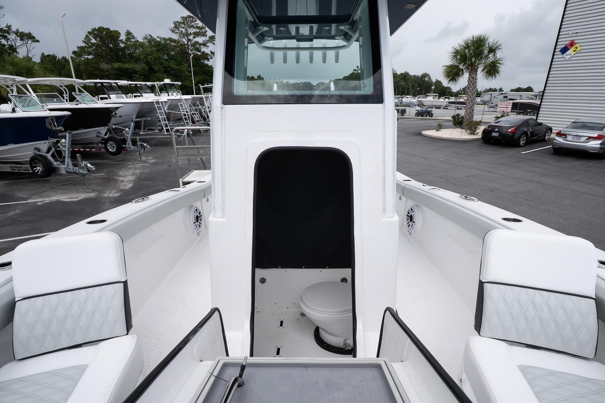2026 Blackfin 262 HB boat interior with seating and a compact toilet area.