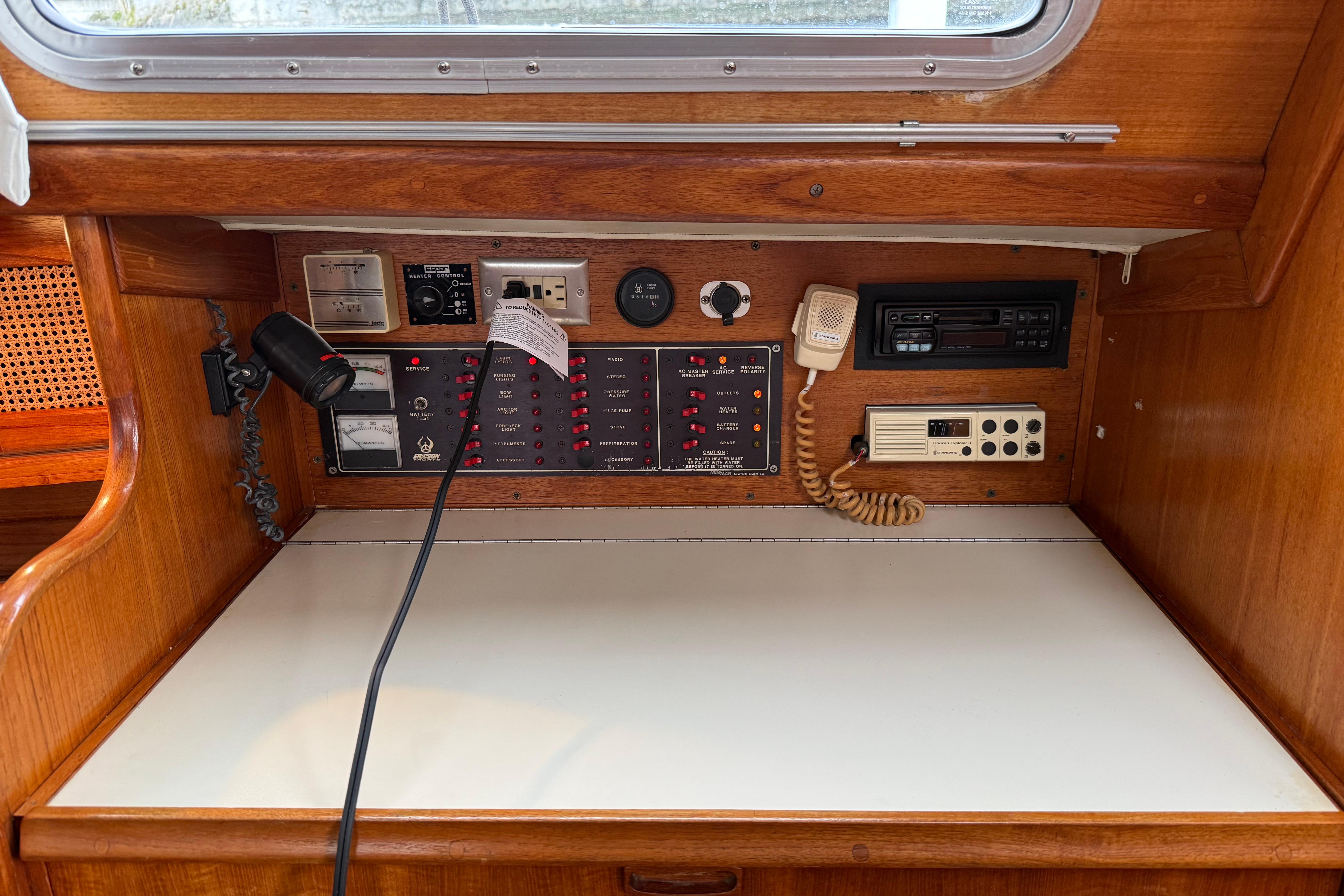 Control panel of a 1988 Ericson 32-200 sailboat with navigation and communication equipment.