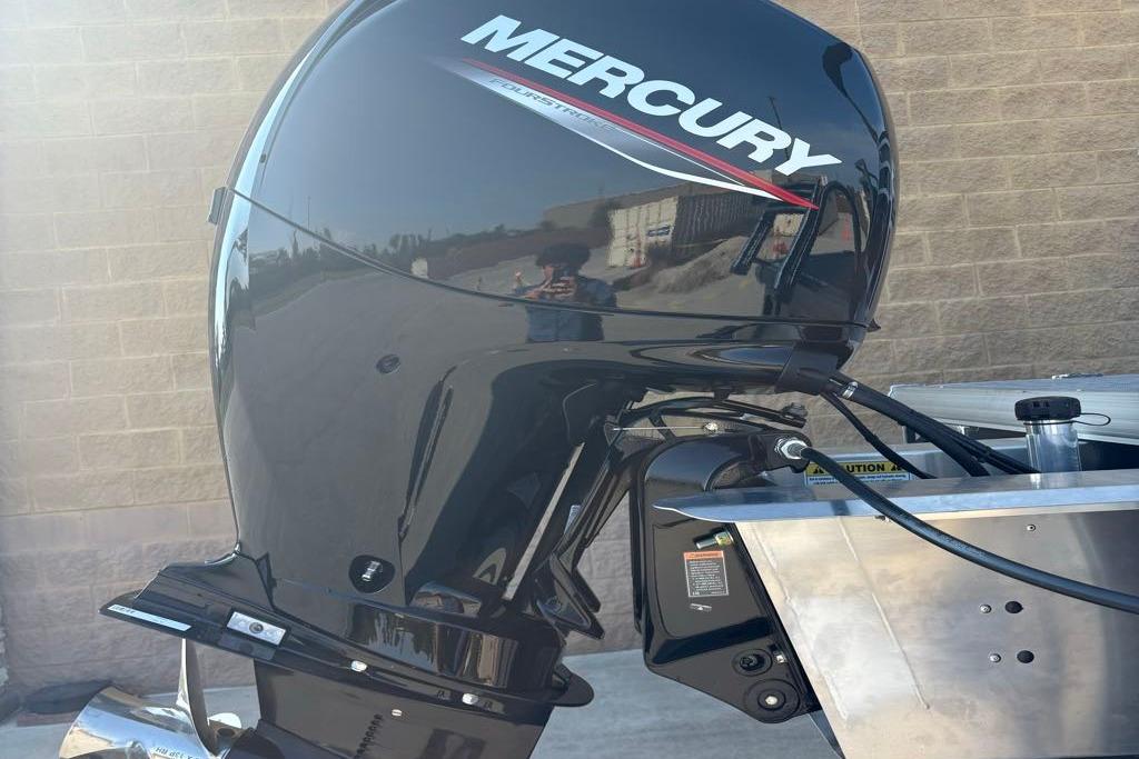 Mercury outboard motor on 2026 Sun Tracker SportFish 22 DLX boat, side view.