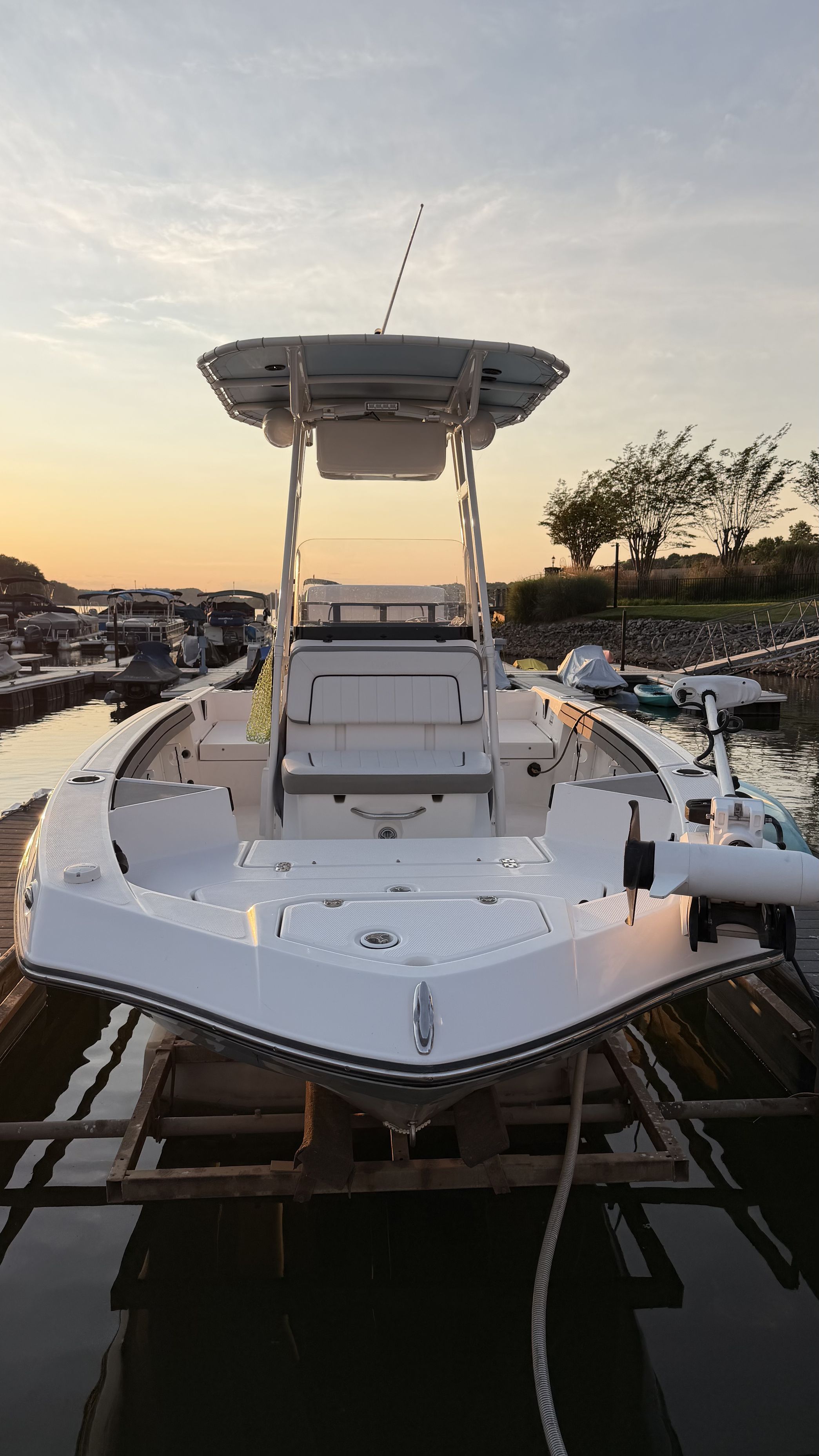 A 2019 Yamaha 190 FSH Sport boat is docked at sunset.