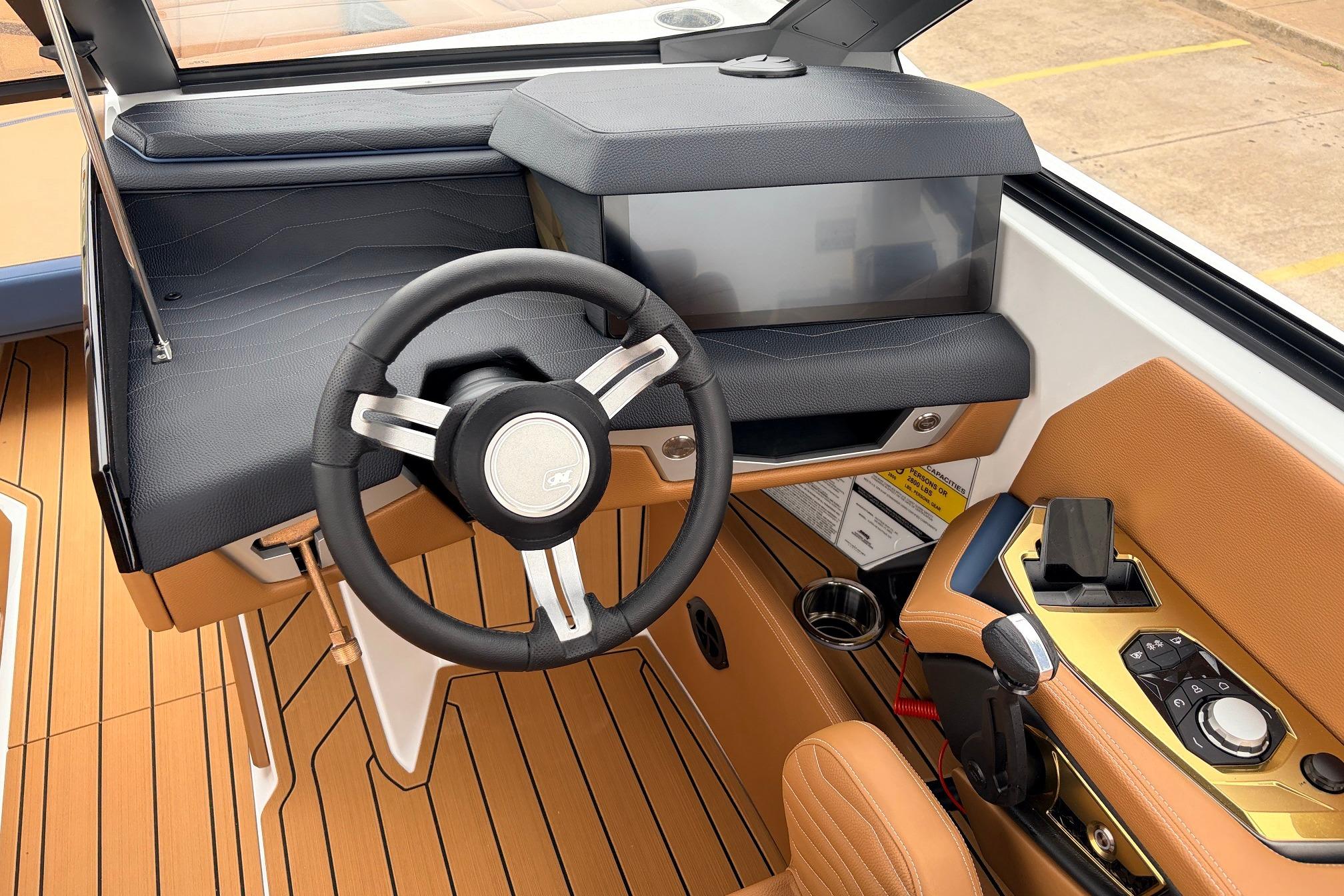 Interior of 2026 Nautique Super Air Nautique G25 boat, featuring sleek steering and controls.