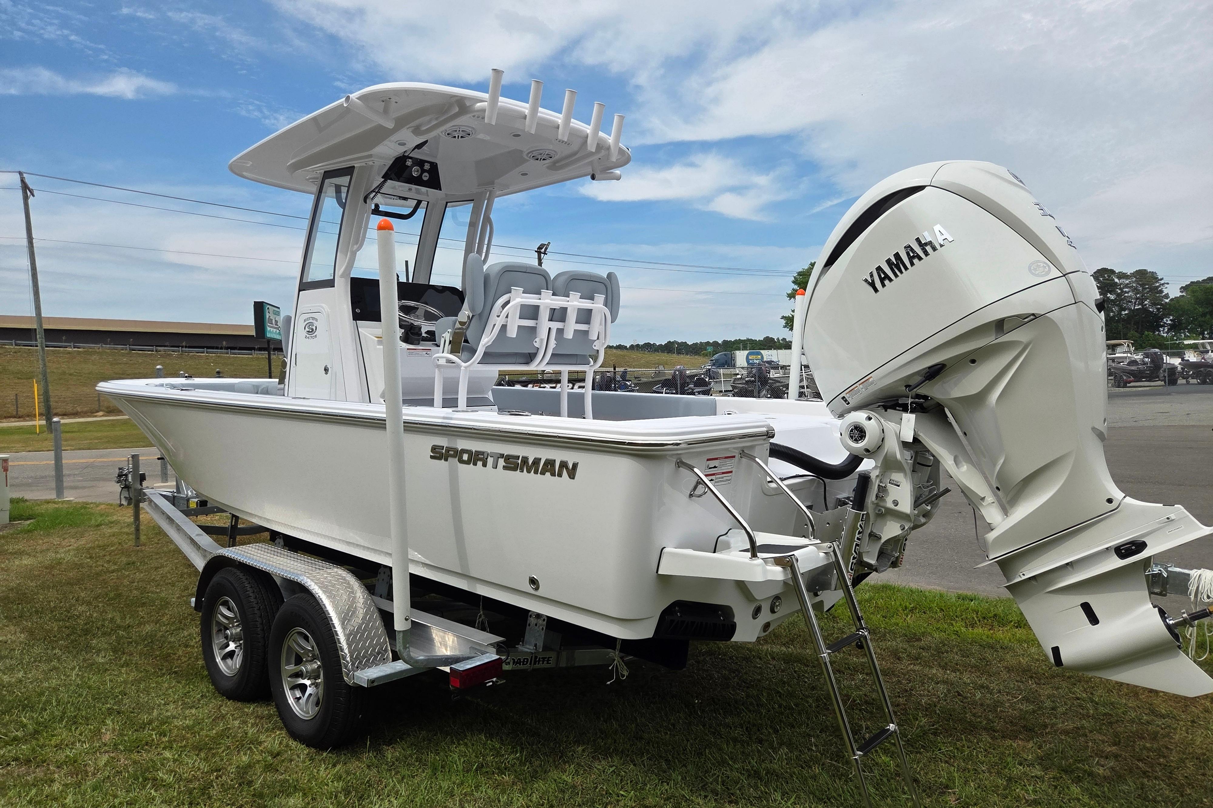 2026 Sportsman Masters 247OE Bay Boat with Yamaha engine on trailer, parked outdoors.