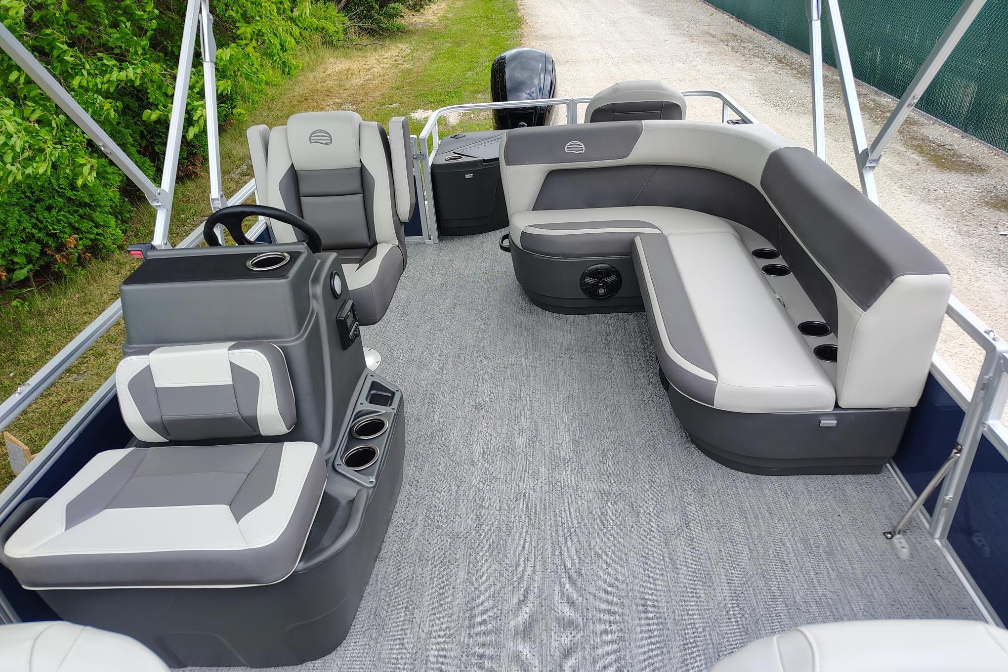 2026 Sun Tracker Bass Buggy 18 DLX pontoon boat interior with gray seating and steering console.