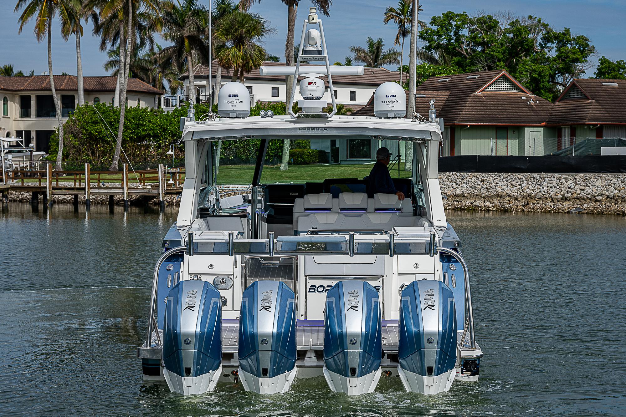 2022 Formula 430 All Sport Crossover boat with four engines on a calm waterway.