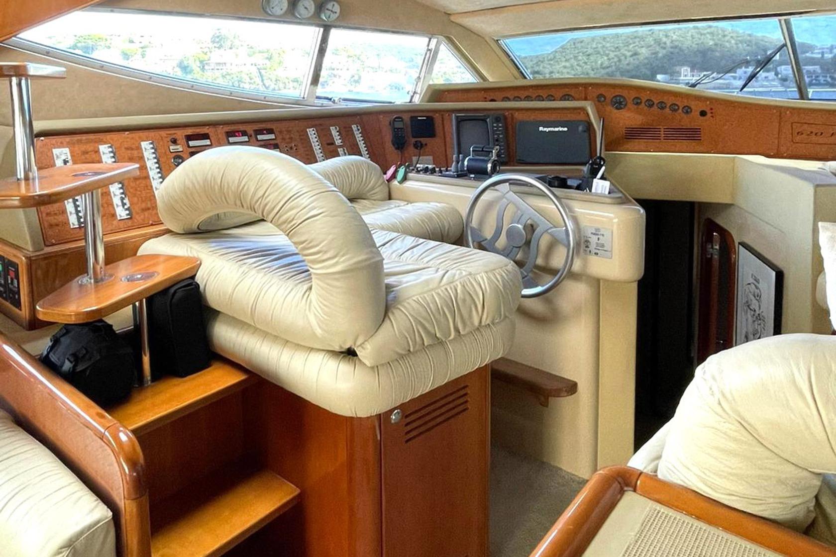 Luxurious interior of 2002 Ferretti Yachts 620 with plush seating and advanced navigation controls.