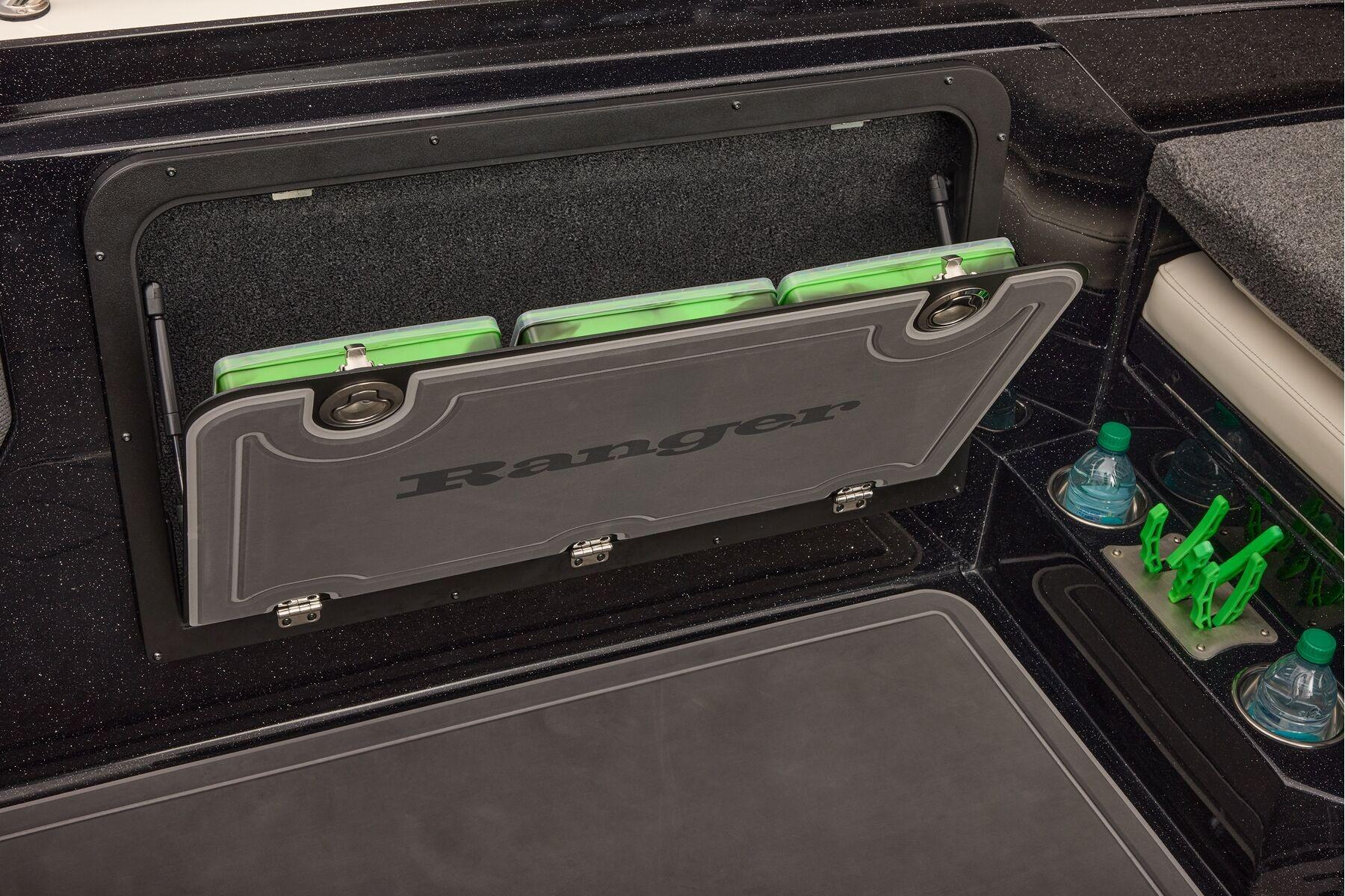 Manufacturer Provided Image: 2026 Ranger 620xFS Pro boat storage compartment with green tackle boxes and cup holders.