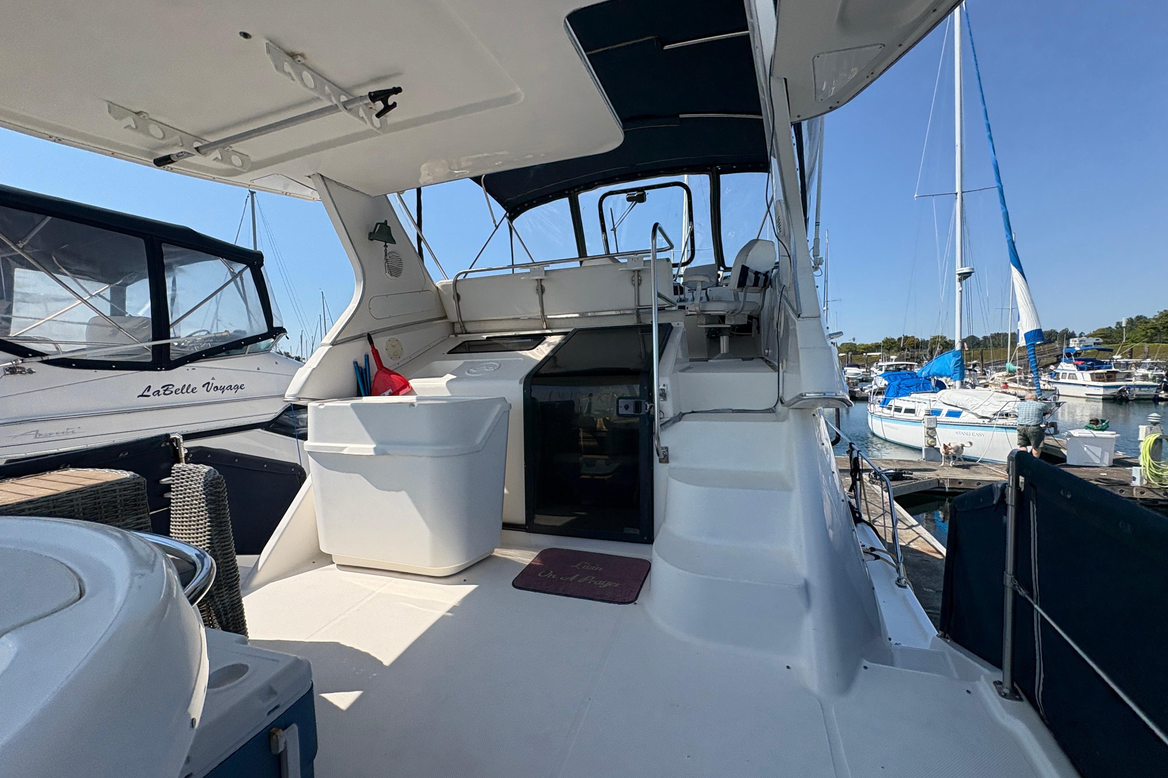 1988 Bayliner 3587 Motoryacht interior with marina view, featuring seating and helm area.