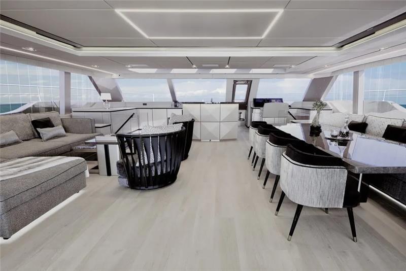 Luxurious interior of 2026 Sunreef 80 Sunreef Power yacht with modern seating and dining area.