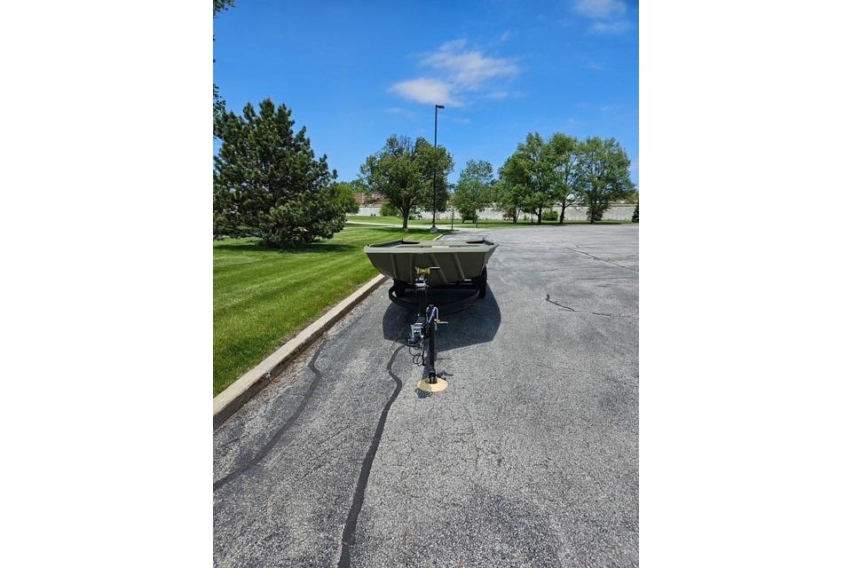 2026 Tracker Grizzly 1754 Utility boat on trailer in parking lot.