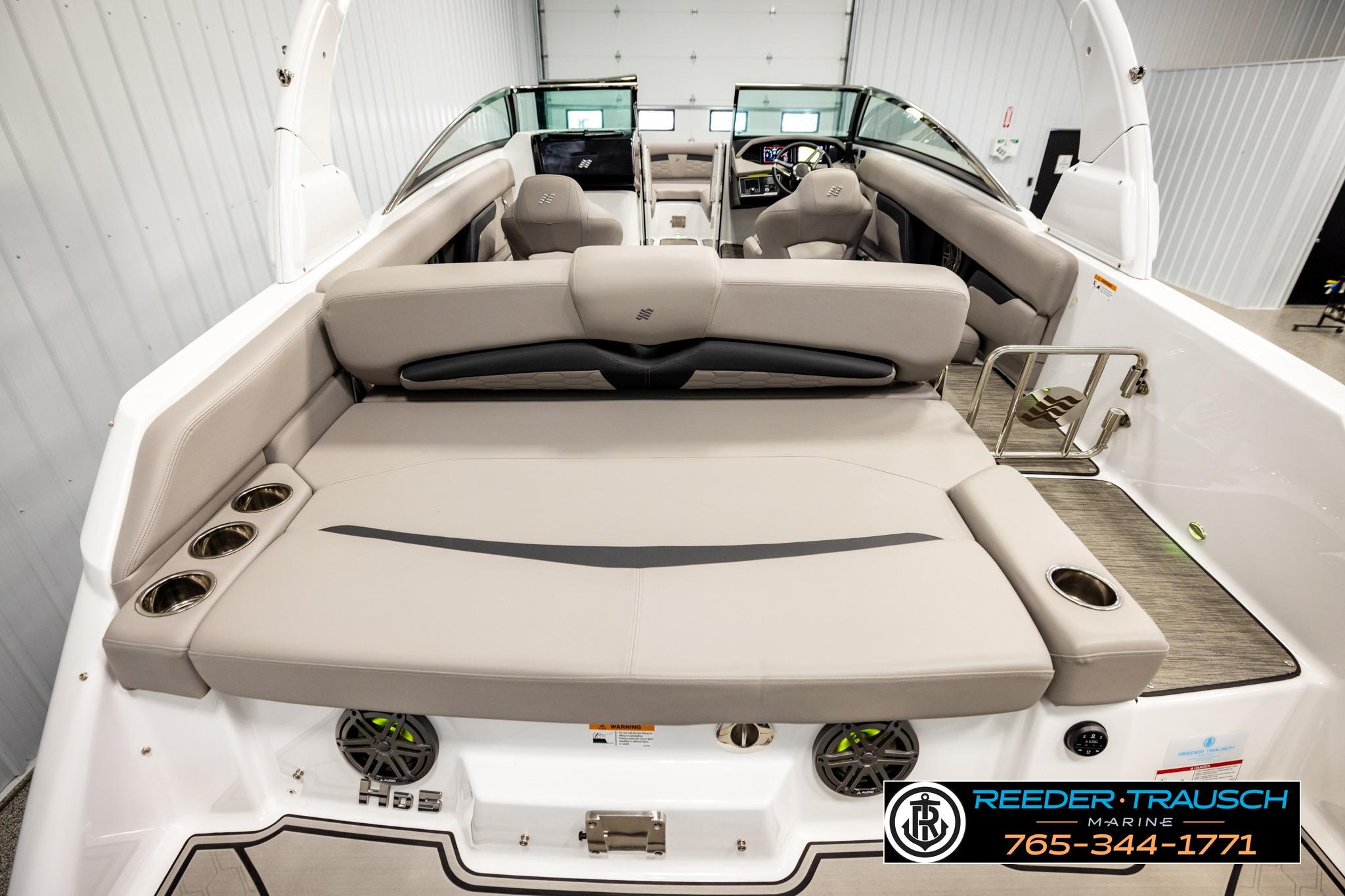 2024 FOURWINNS HD5 Surf boat interior with beige seating and modern dashboard.