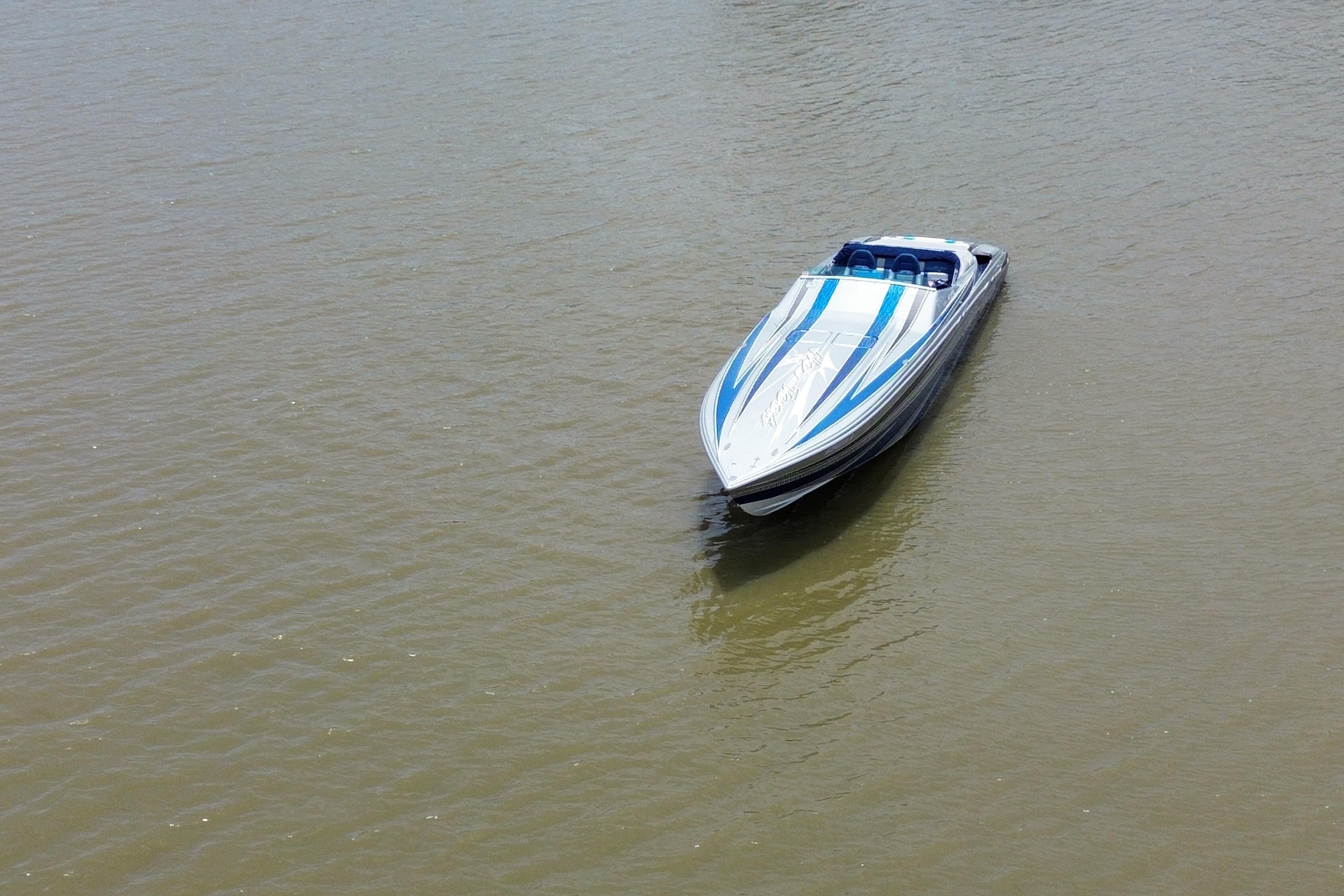 2013 Nor-Tech 477 SPX Vee Bottom speedboat on calm water, showcasing sleek design.