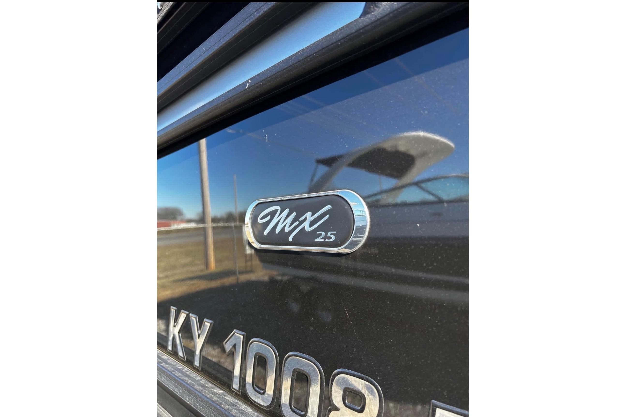 2023 Starcraft MX 25 DL DH boat emblem with reflective surface.