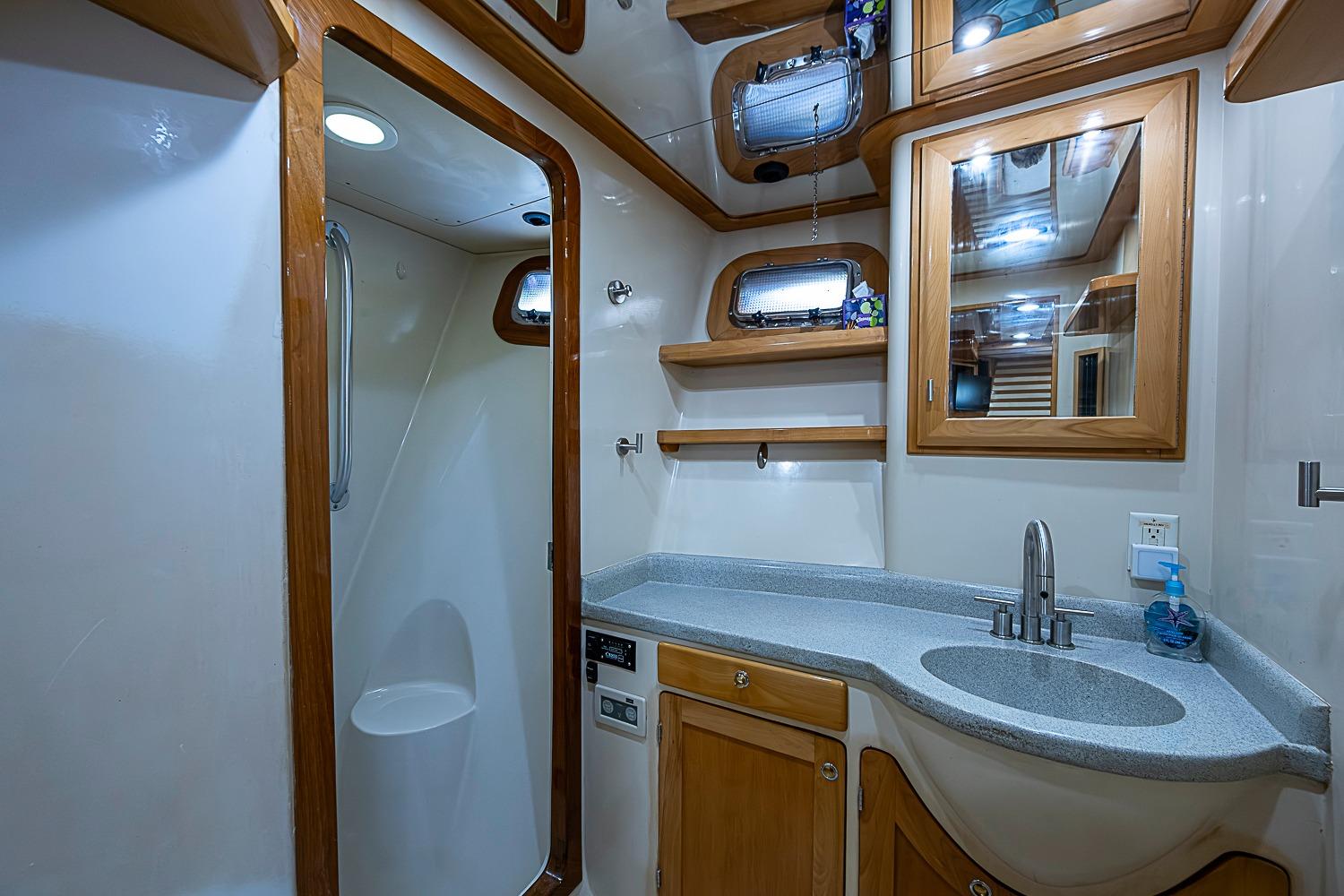 Bathroom interior of 2003 Magna Marine Nova Scotia 47 yacht with shower and sink.