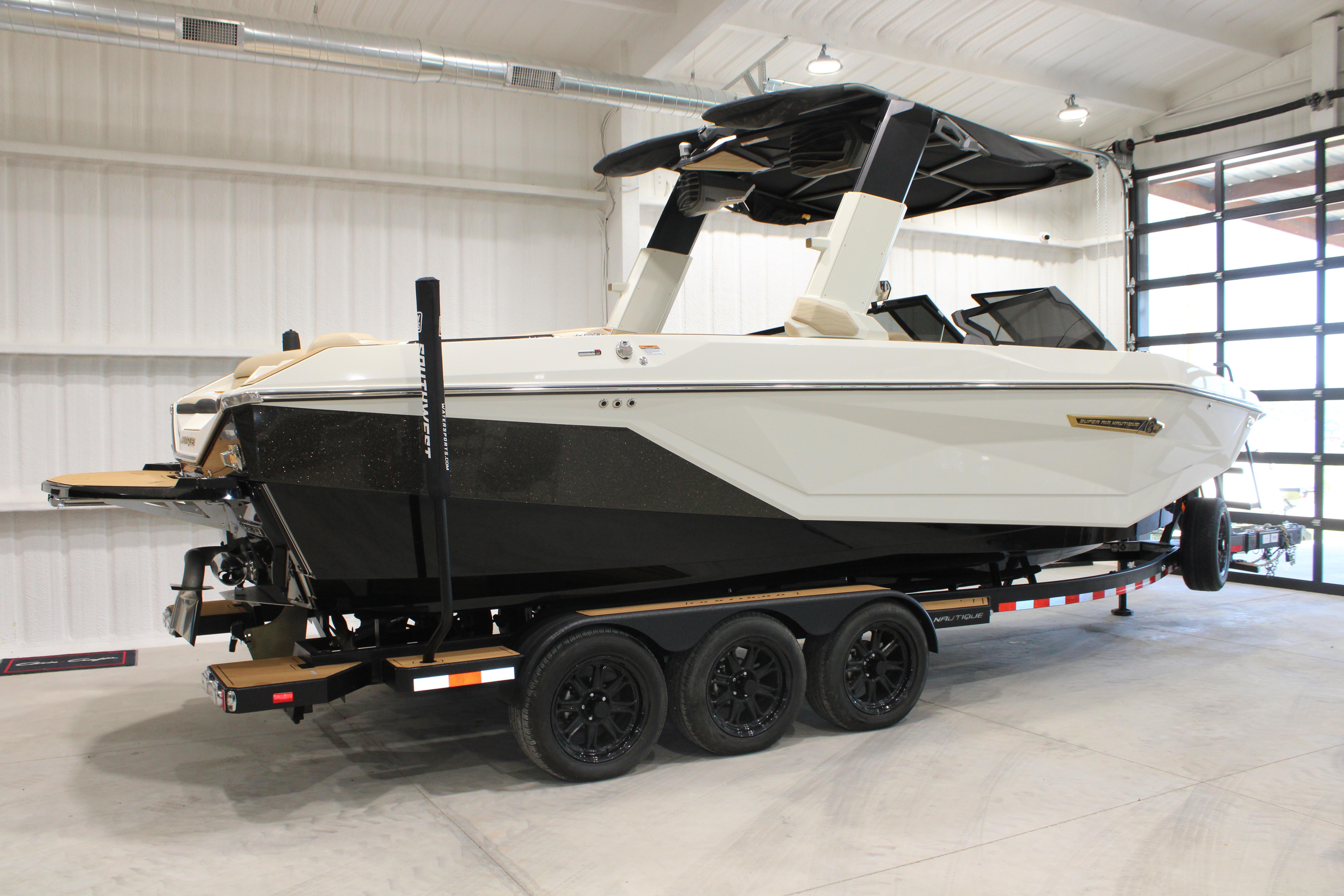 2025 Nautique Super Air Nautique G25 boat on trailer in indoor storage.