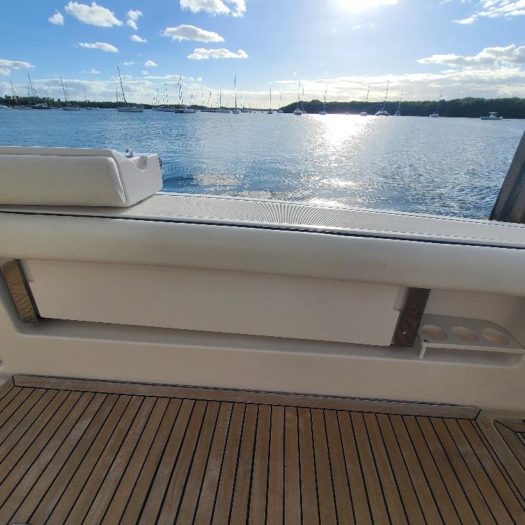 2003 Tiara Yachts 3800 Open, teak deck, serene waterfront view.