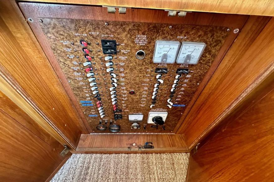 Electrical panel of a 1985 Egg Harbor 33 Sedan boat with switches and meters.