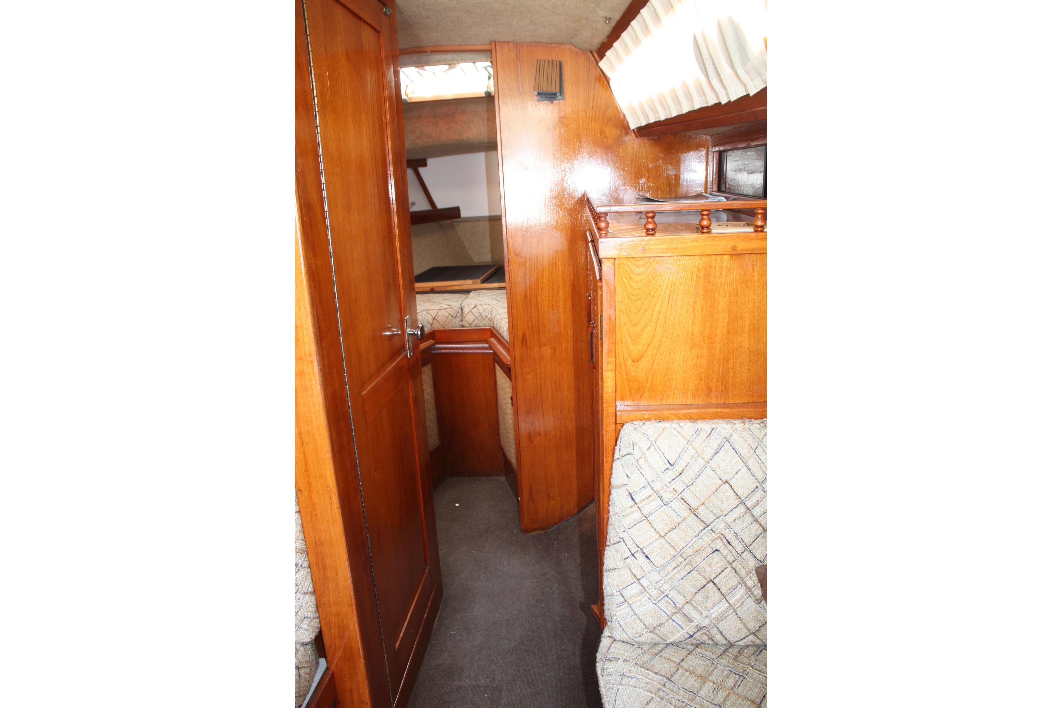 Interior of 1981 S2 9.2A sailboat with wooden cabinetry and cozy seating area.