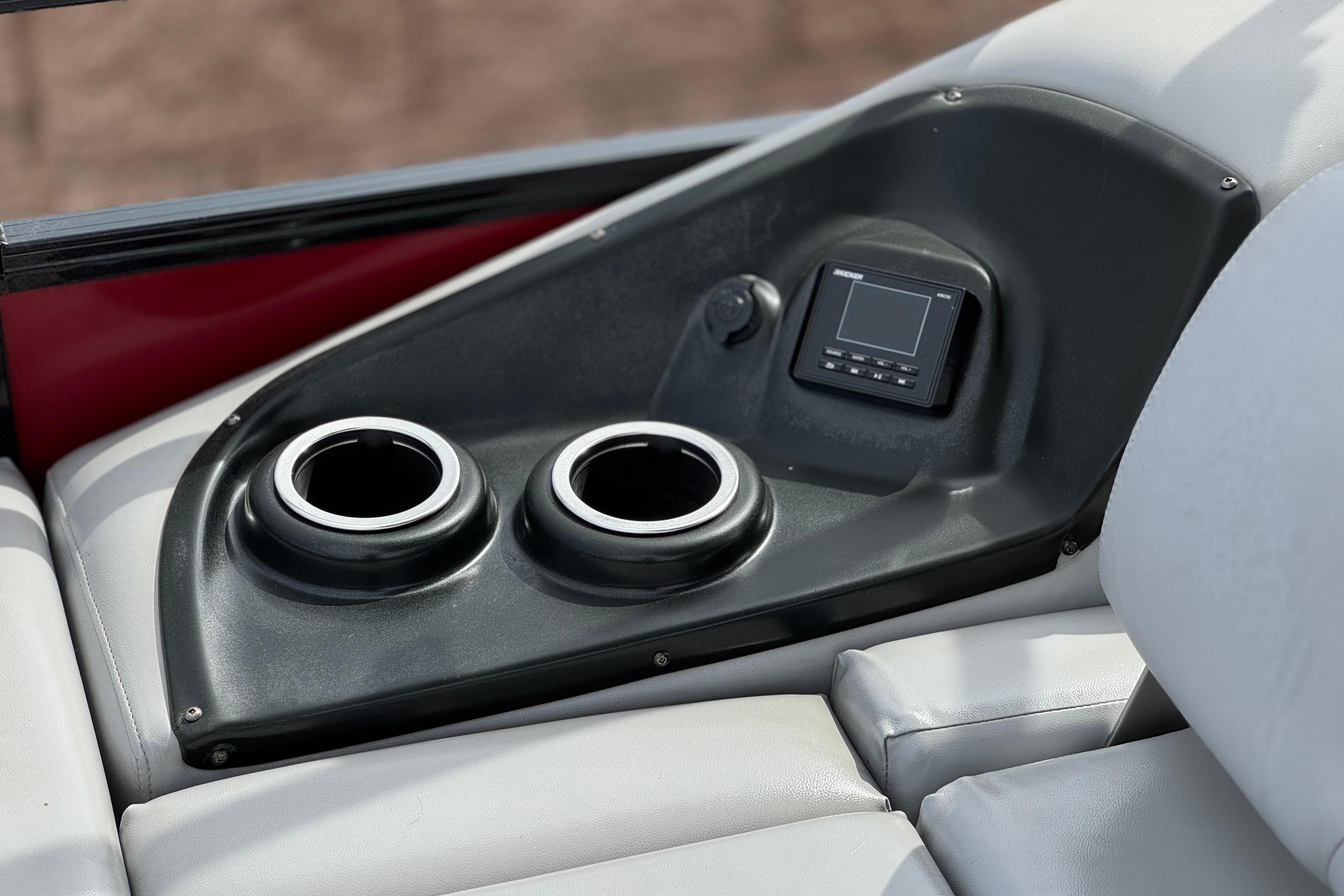 Cup holders and control panel on 2022 Regency 250 DL3 boat interior.