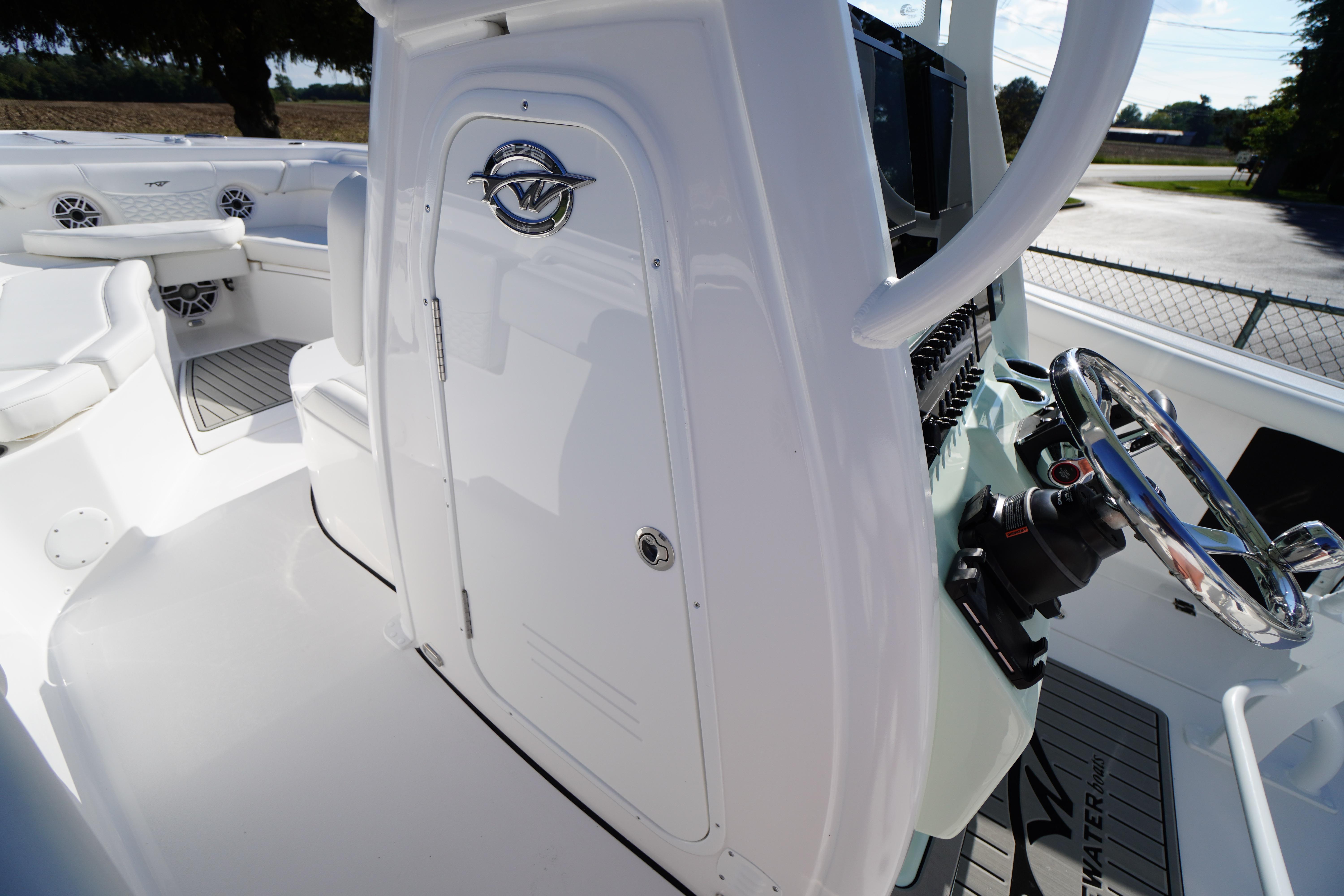 2026 Tidewater 272 LXF boat interior with steering wheel and seating area.