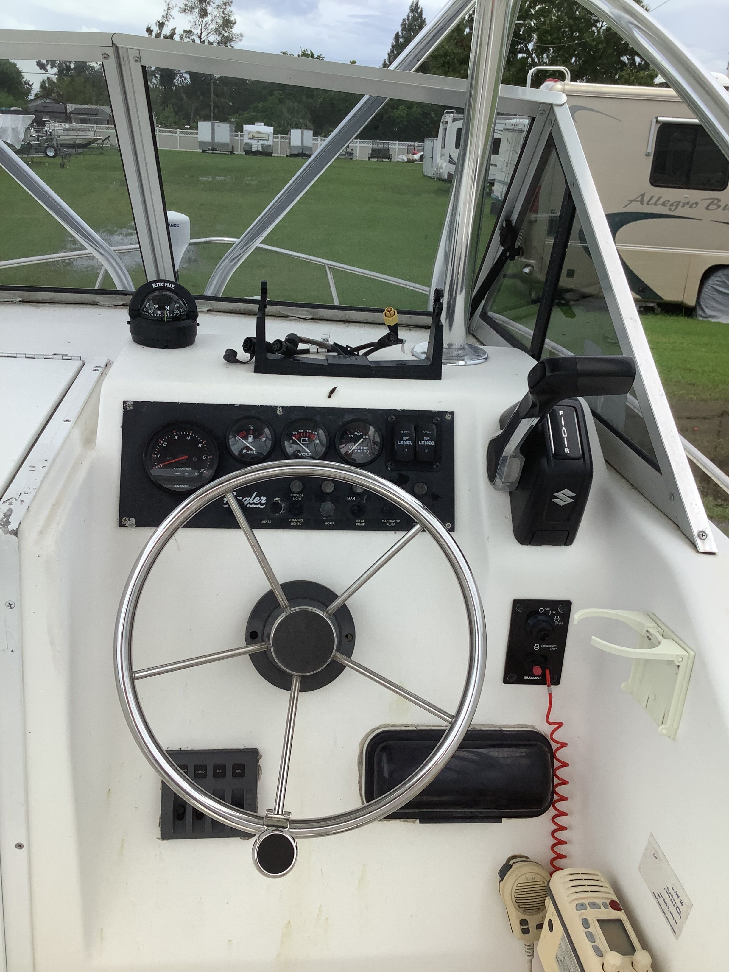 The cockpit of an Angler boat with a steering wheel and instrument panel.