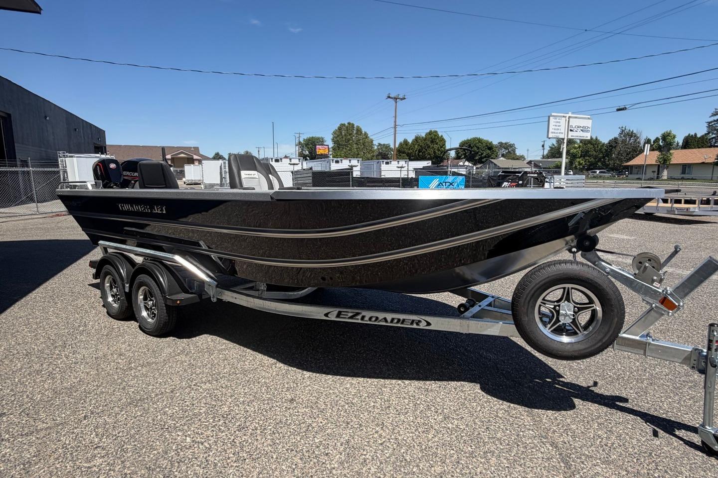 2026 Thunder Jet 209 Rush OT boat on trailer, parked outdoors under clear sky.