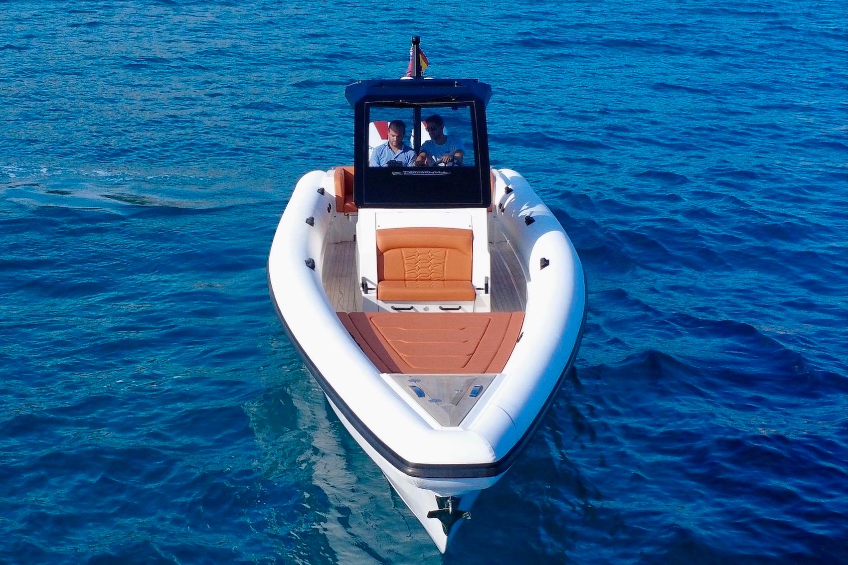 2025 Technohull 38 Grand Sport boat cruising on clear blue water.