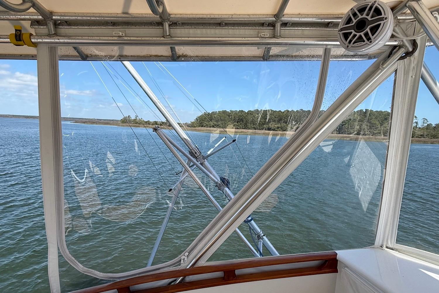 1963 Rybovich 45 Convertible boat interior with water and shoreline view.