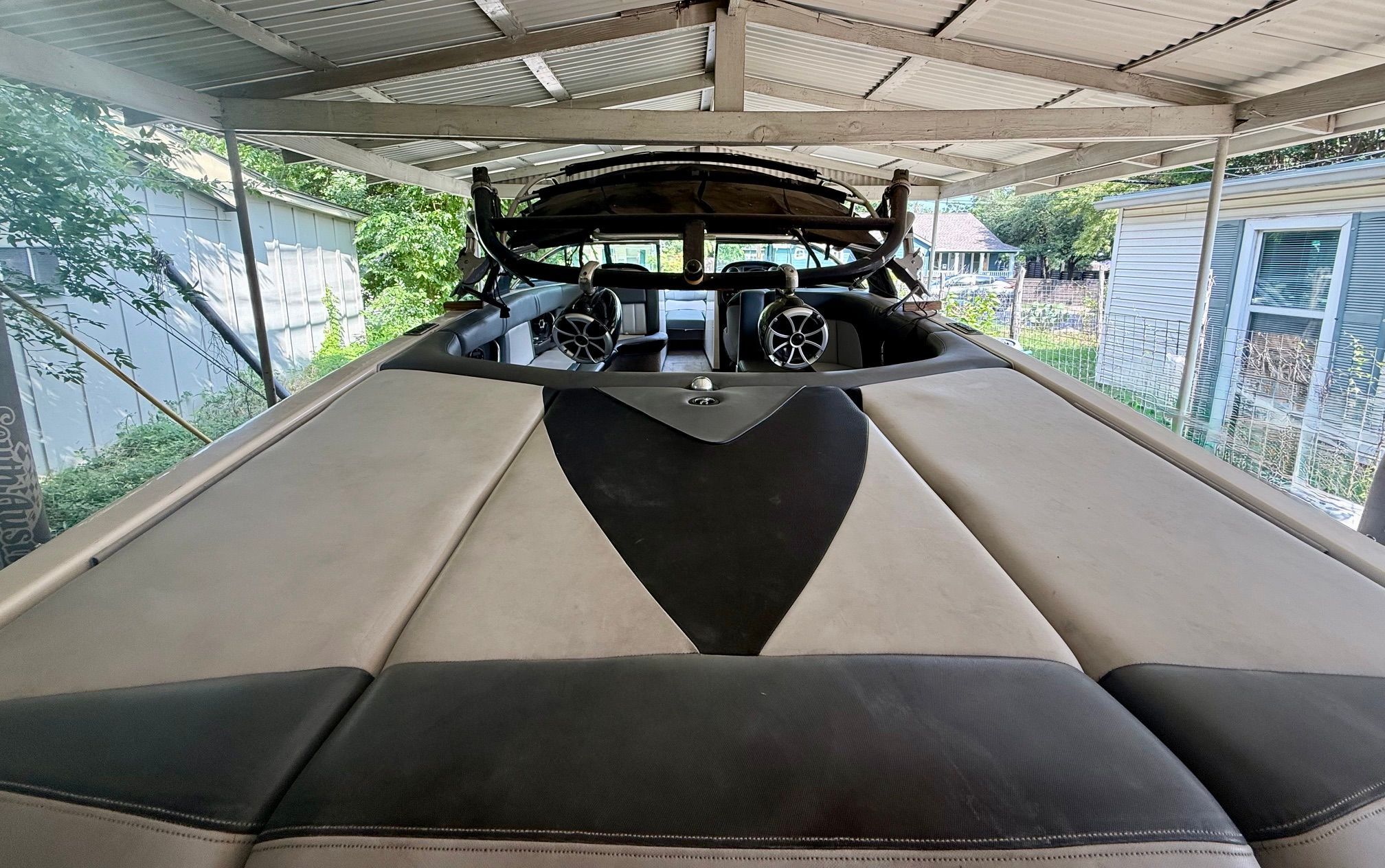 The image shows the deck of a 2012 Supra Launch 242 boat under a carport.