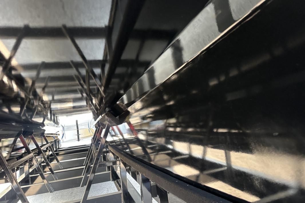 Close-up of Wright Performance 420 boat hull, 2018 model, showing sleek black surface and structure.