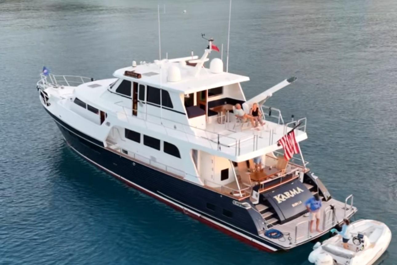 2023 Marlow Explorer 66E-CB yacht on serene water, featuring spacious deck and luxury amenities.