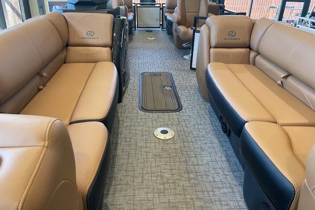Luxurious interior of 2026 Regency 230 DL pontoon boat with tan leather seating.