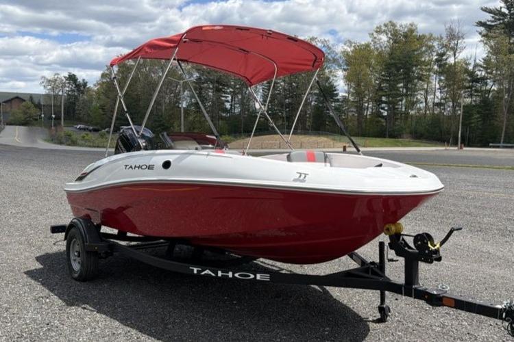 2026 Tahoe T16 boat with red canopy on trailer, parked outdoors.