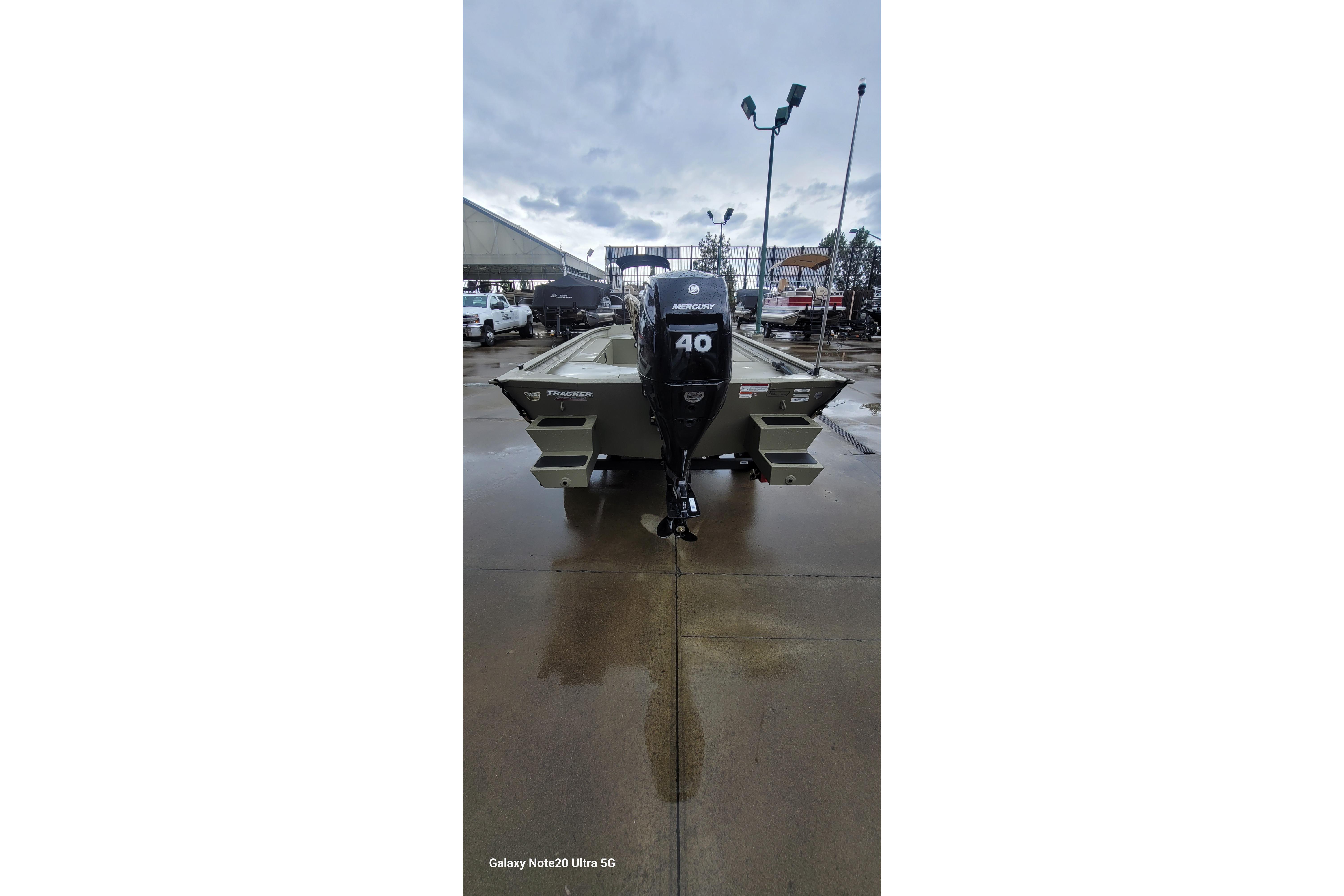2026 Tracker Grizzly 1654 T Sportsman boat with Mercury 40 engine, parked outdoors.