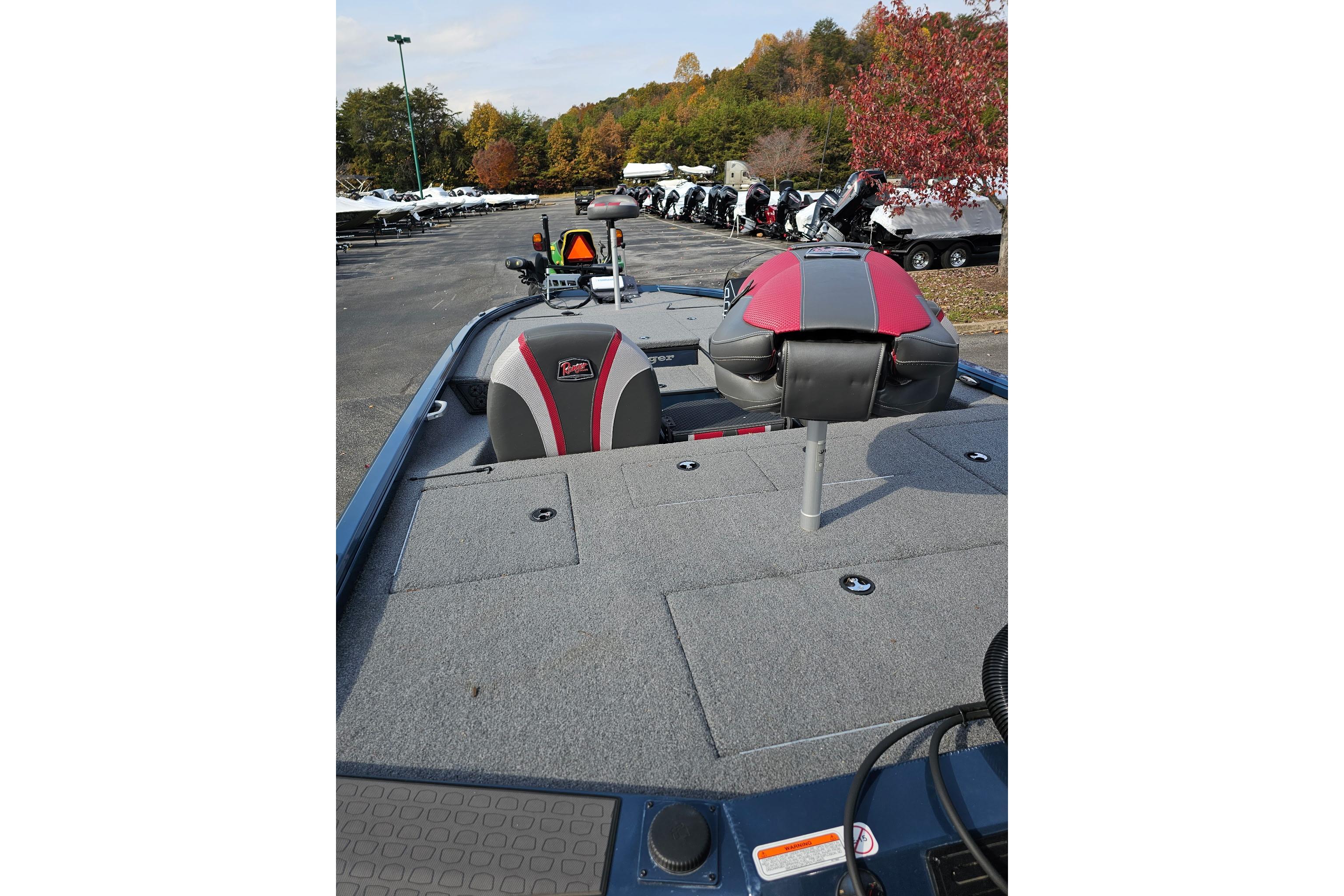 2025 Ranger ALPHA 208 boat interior with red and gray seating, parked outdoors.
