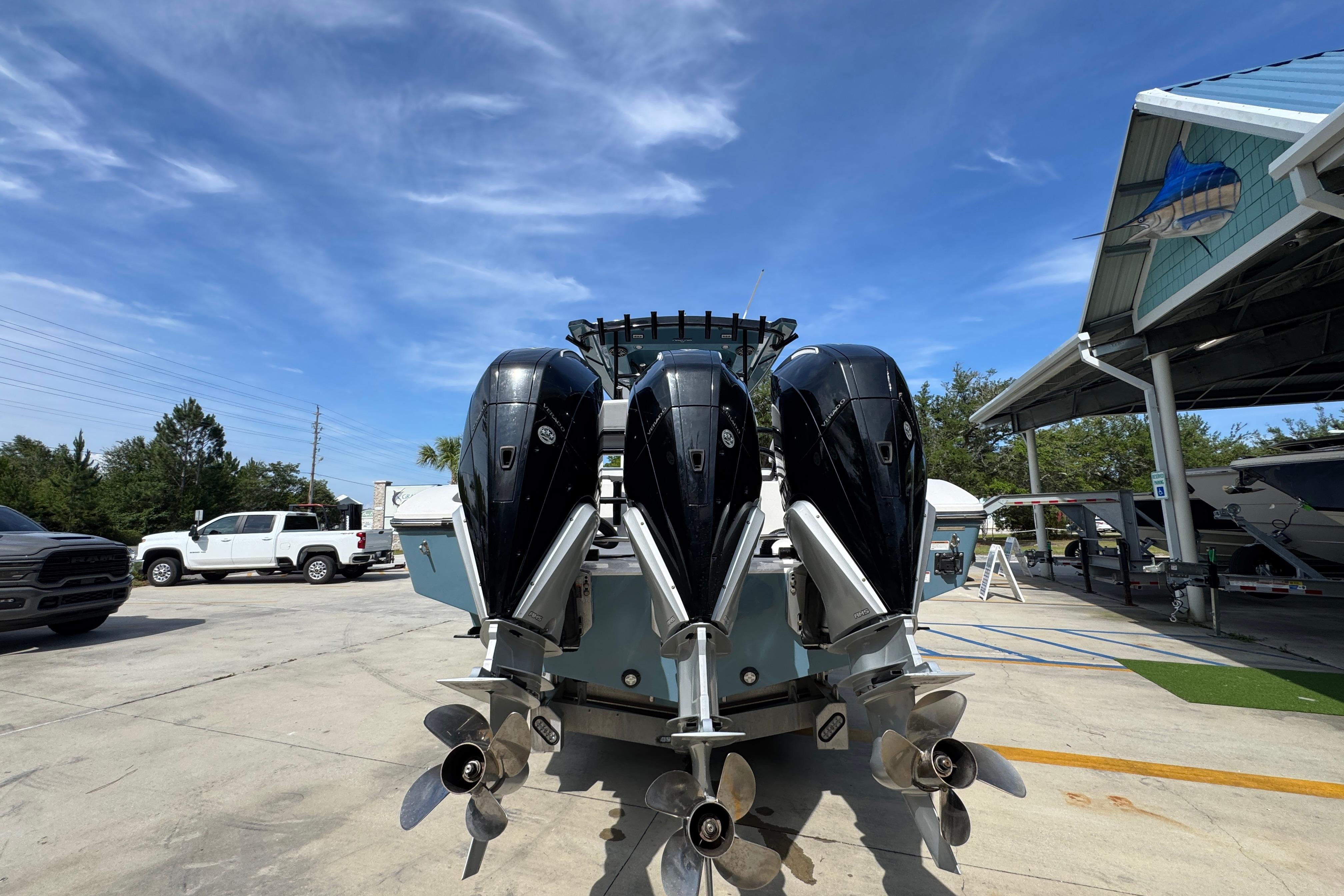 2023 Fountain 34 Tournament Edition boat with triple outboard engines in a marina setting.