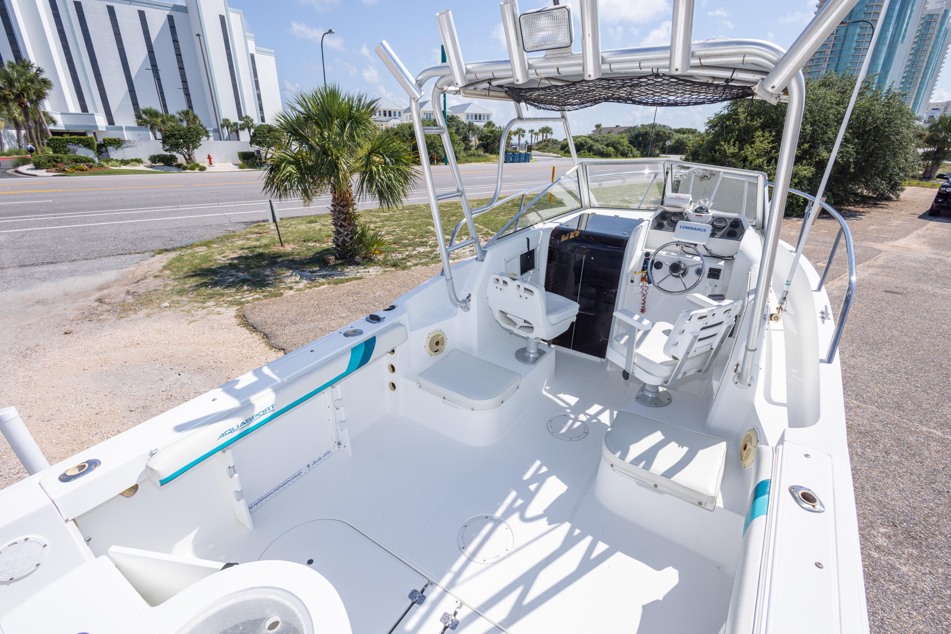1999 Aquasport 225 Explorer boat with spacious cockpit and modern controls.
