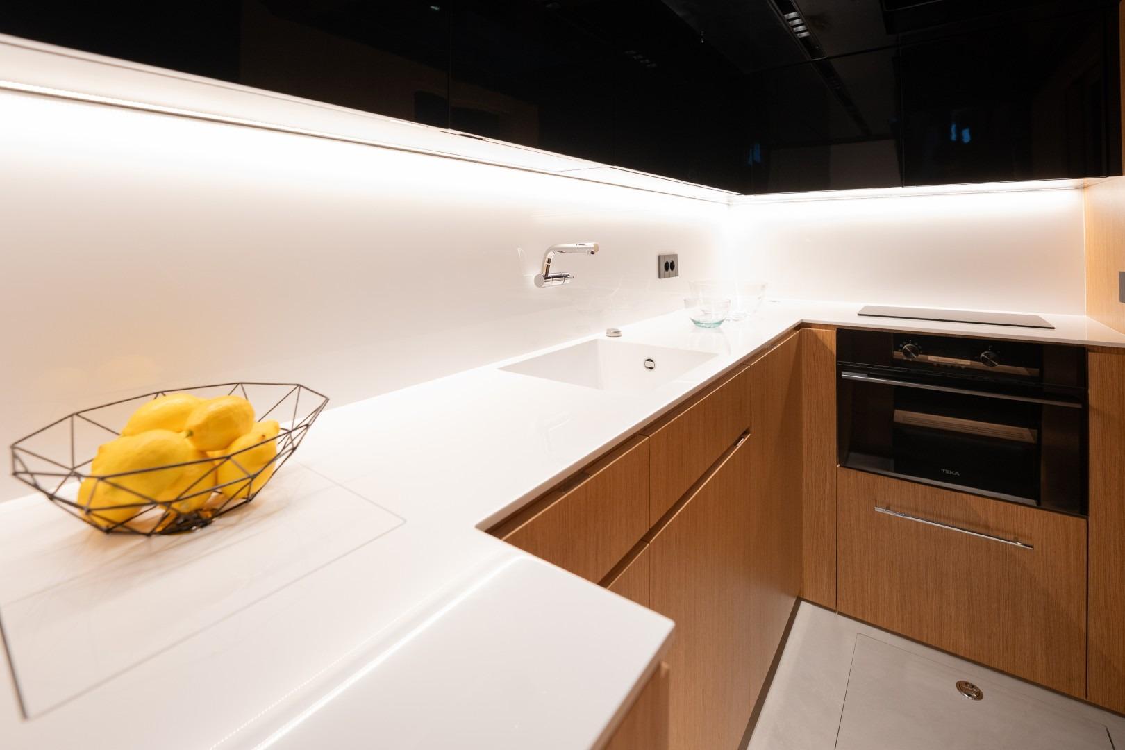 Modern kitchen interior on 2026 De Antonio Yachts D60, featuring sleek design and wooden cabinetry.