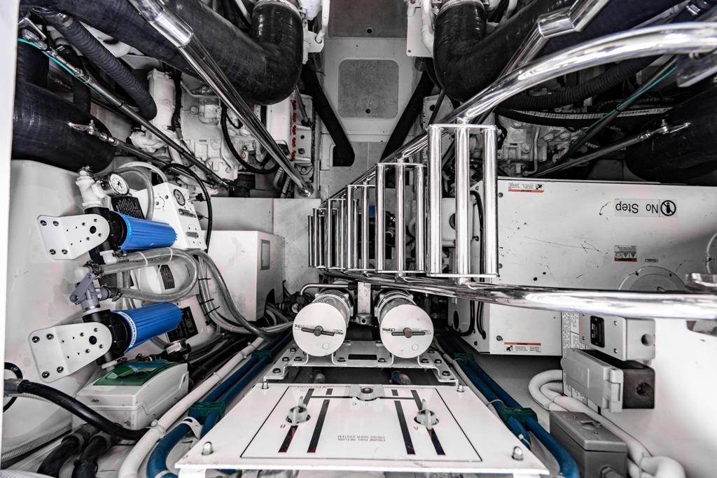 Engine room of 2020 Fairline 68 yacht, showcasing mechanical components and piping.