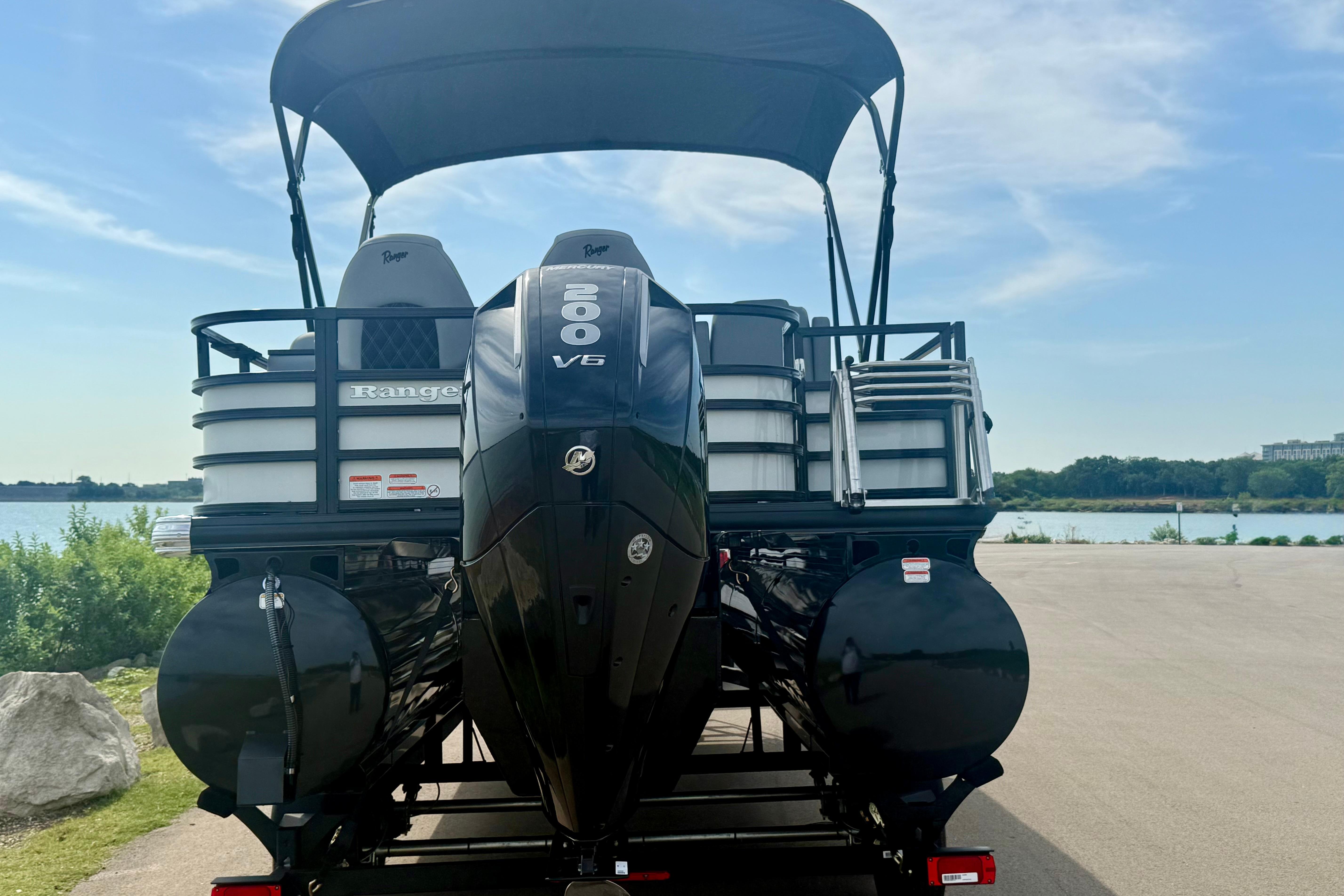 2026 Ranger 223FC pontoon boat with V6 engine, parked by a scenic lake.