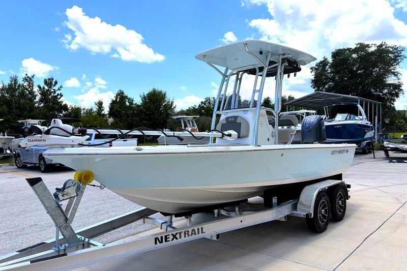 2025 Key West 210 Bay Reef boat on trailer, parked outdoors under a clear sky.