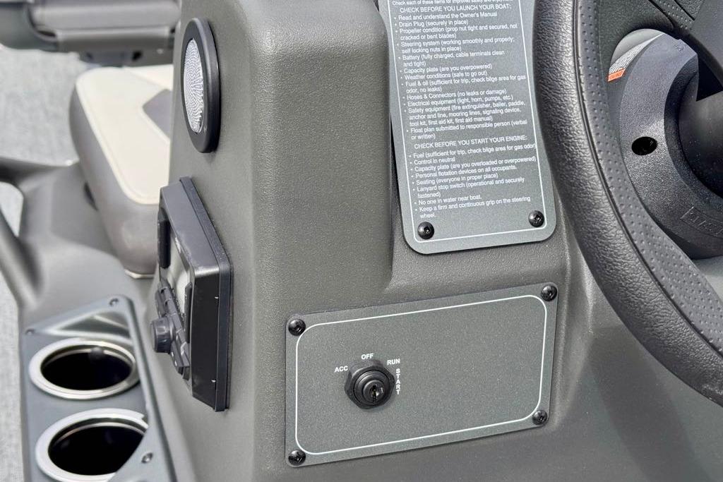 Control panel of 2026 Sun Tracker Bass Buggy 18 DLX with ignition switch and cup holders.